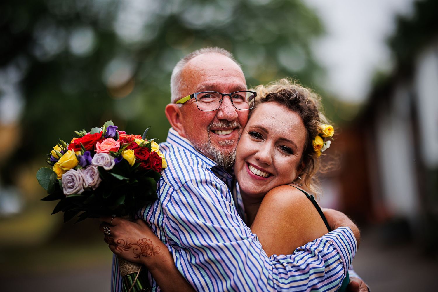 Joyful moment shared with colorful wedding bouquet.