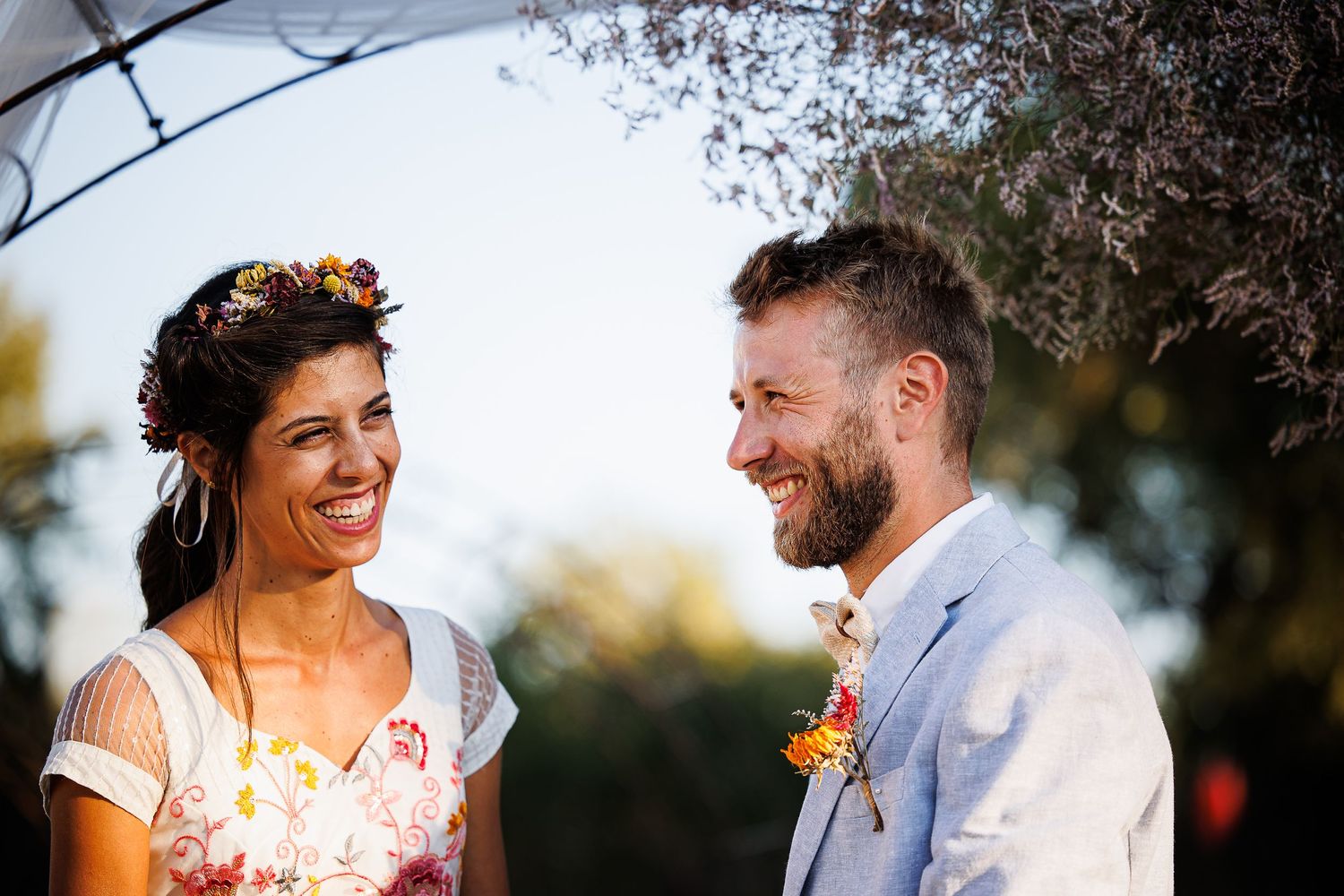 Couple sharing joyful moment during outdoor wedding ceremony.