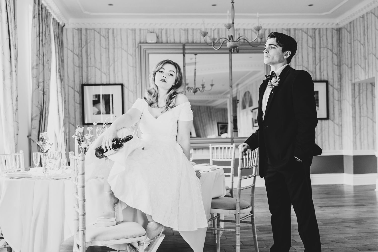 At the end of the day, a bride empties the last of the wine as her groom looks on.