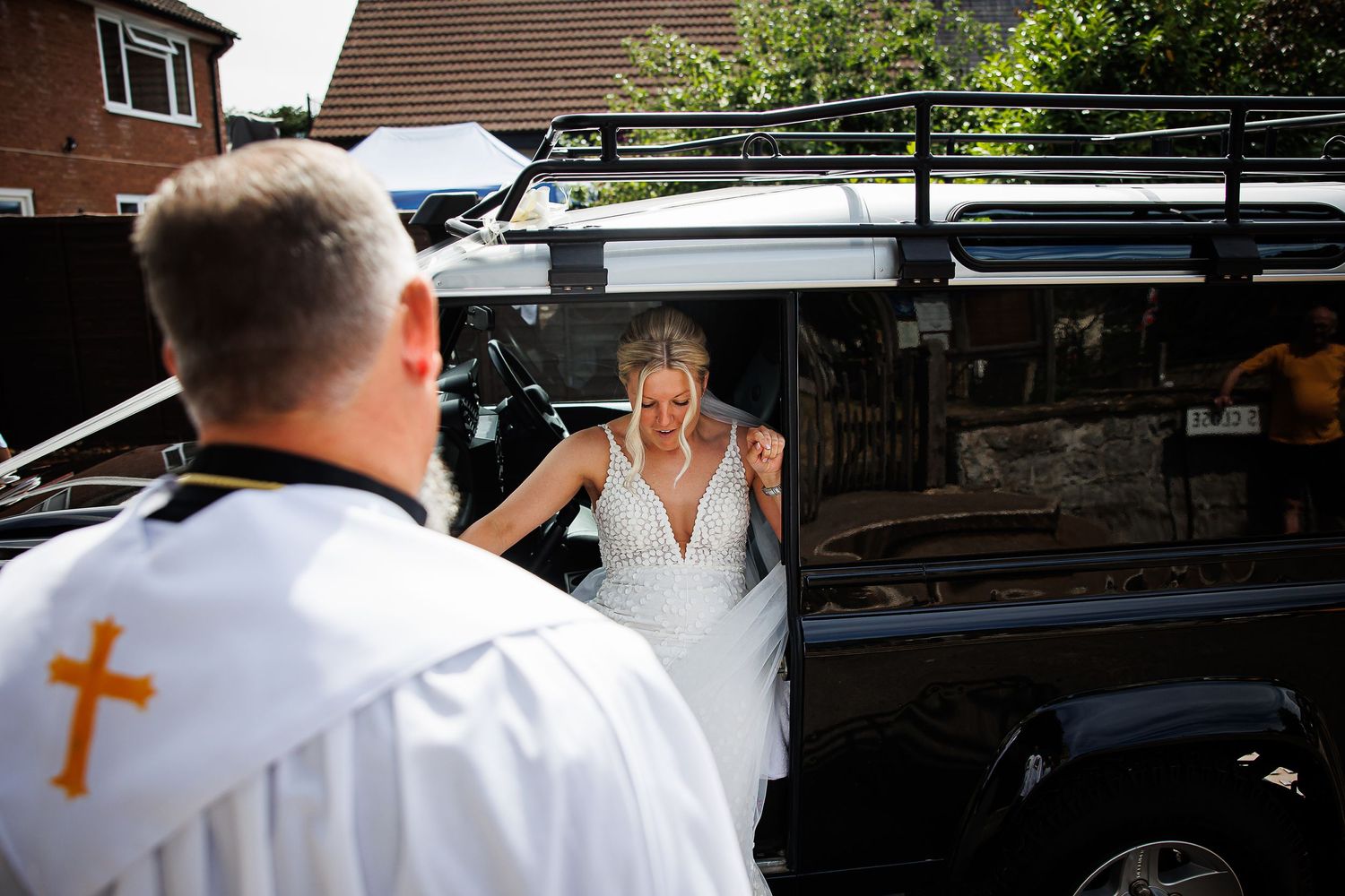 Clergy member greets arriving bride before ceremony.