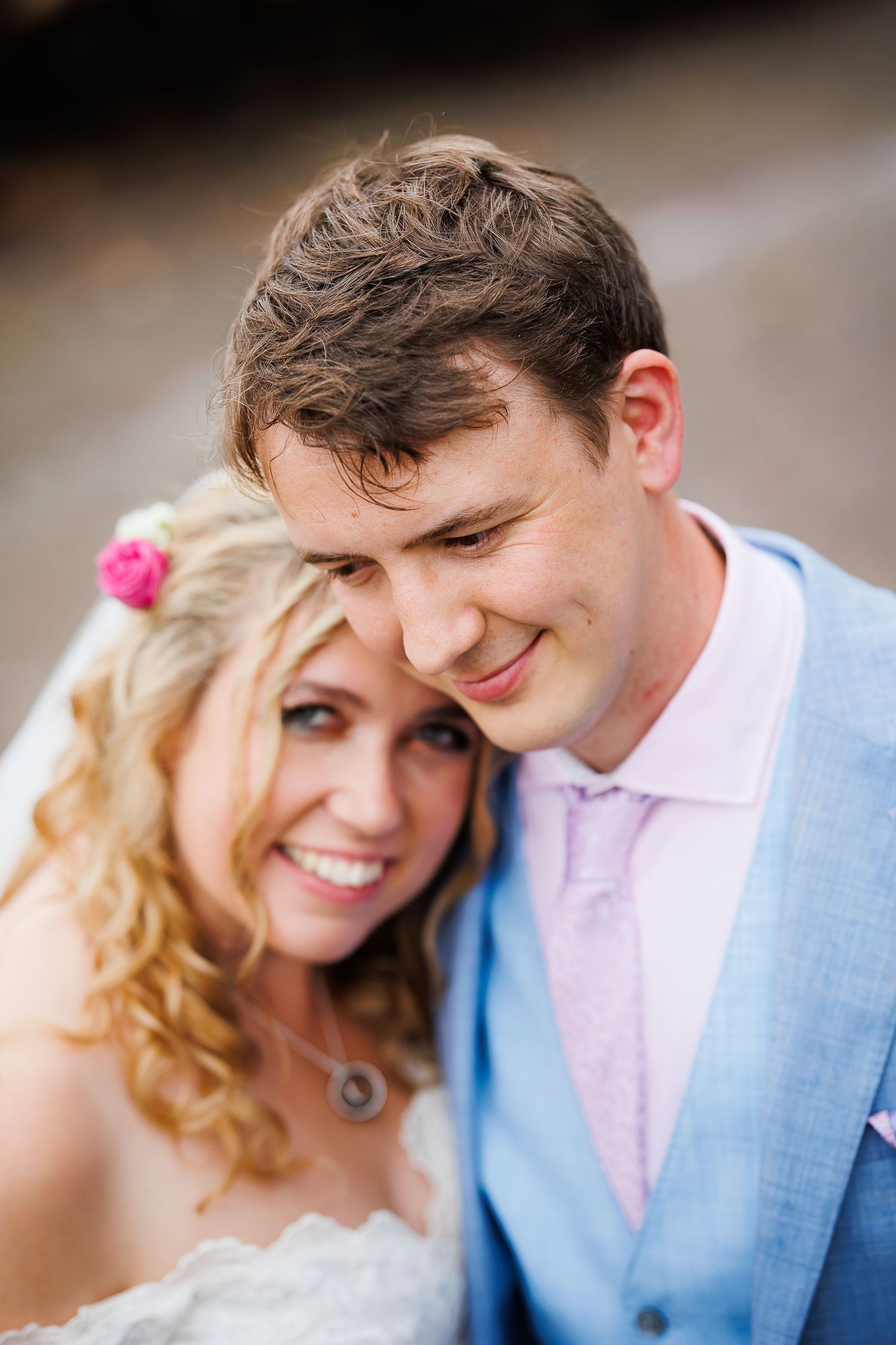 Close emotional portrait of a couple in wedding attire.