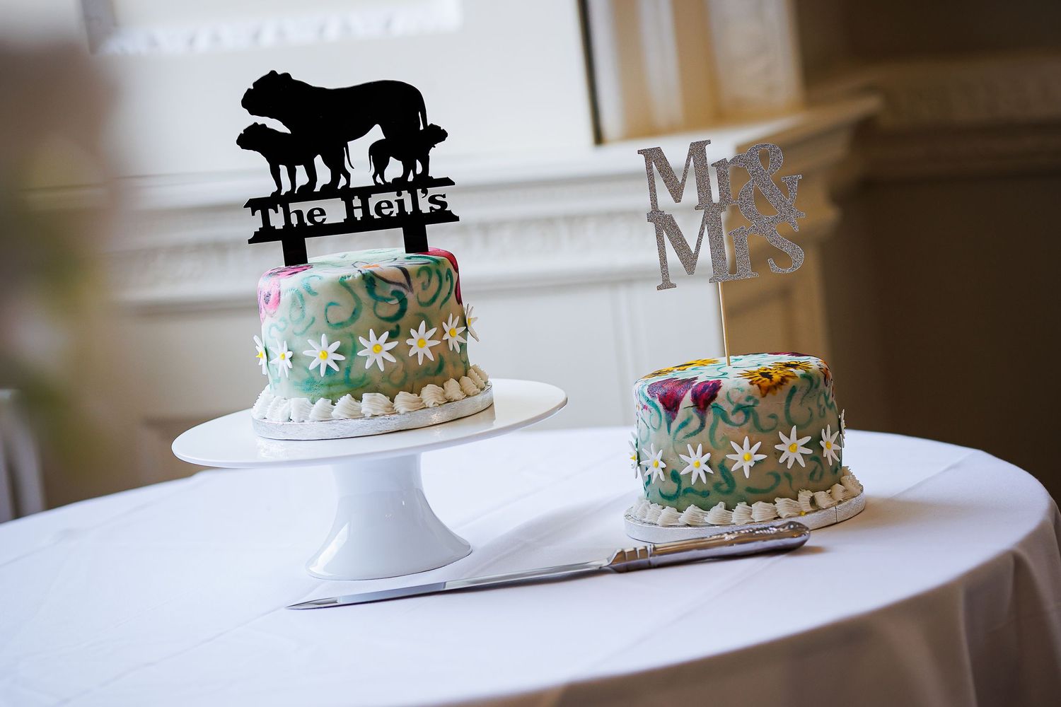 Two small wedding cakes with animal silhouette topper and Mr & Mrs decorations.