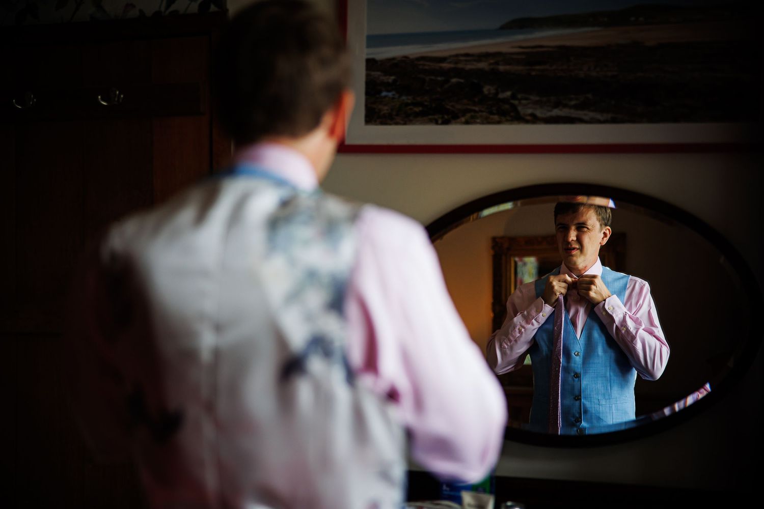 Reflection of formal attire preparation in a mirror.