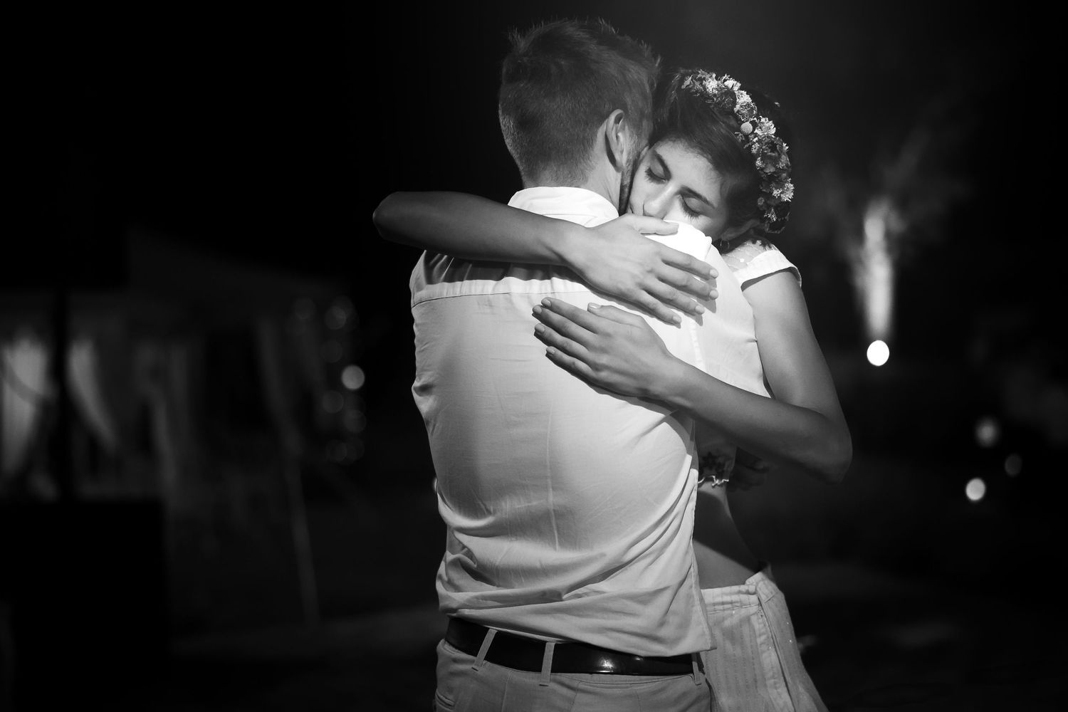 An intimate dance moment captured in black and white during an evening celebration.
