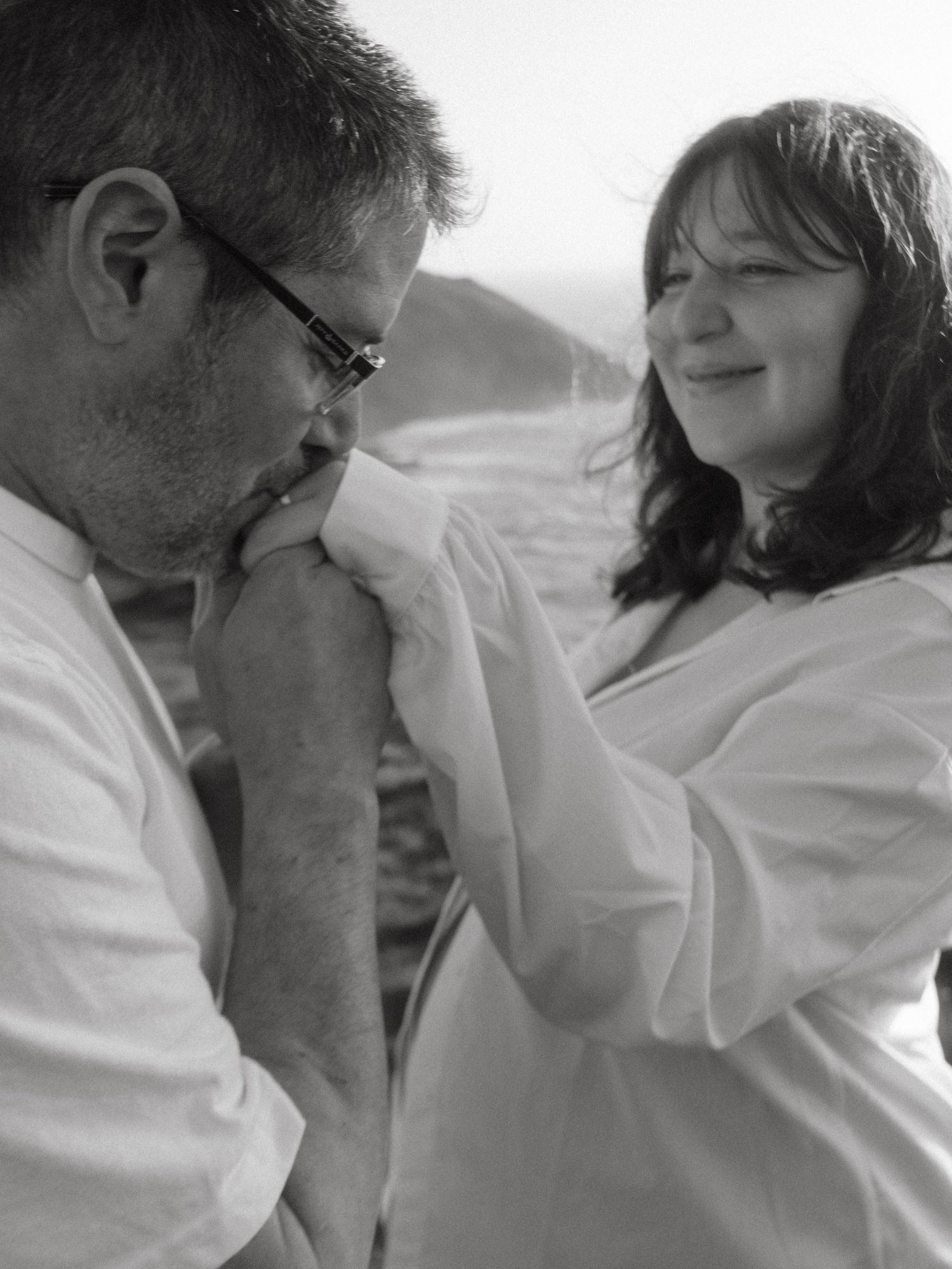 Black and white photo of Couple, he's kissing her hand