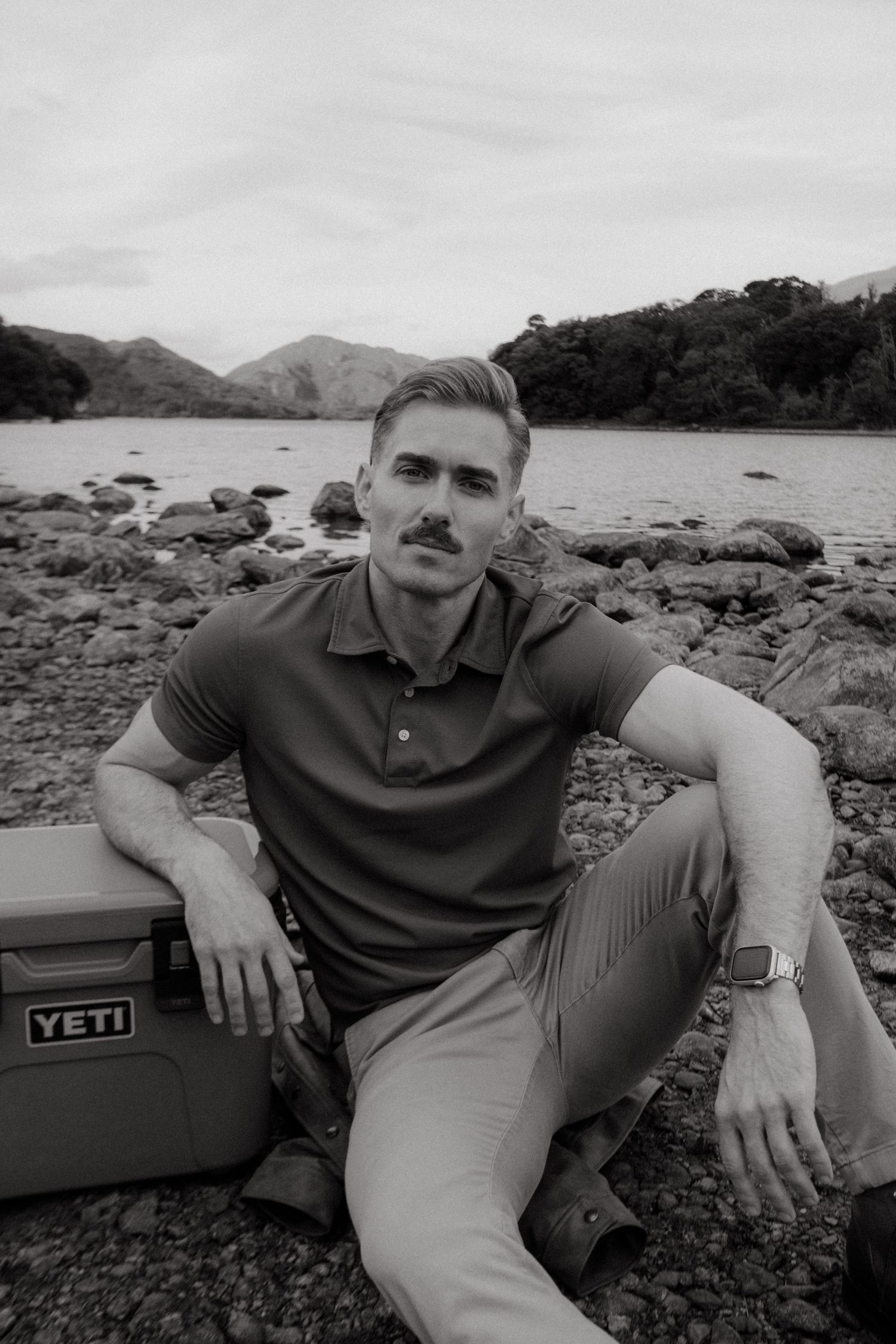 Portrait of young man in Killarney National Park, he has short blonde hair and a mustache.