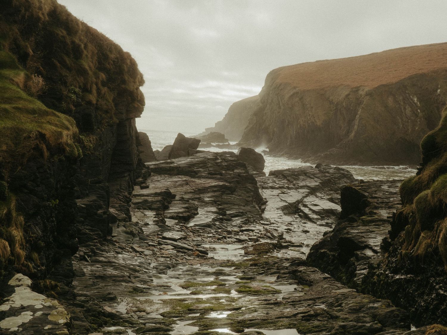 Photograph of couple posing at Nohoval Cove in Cork, Ireland.