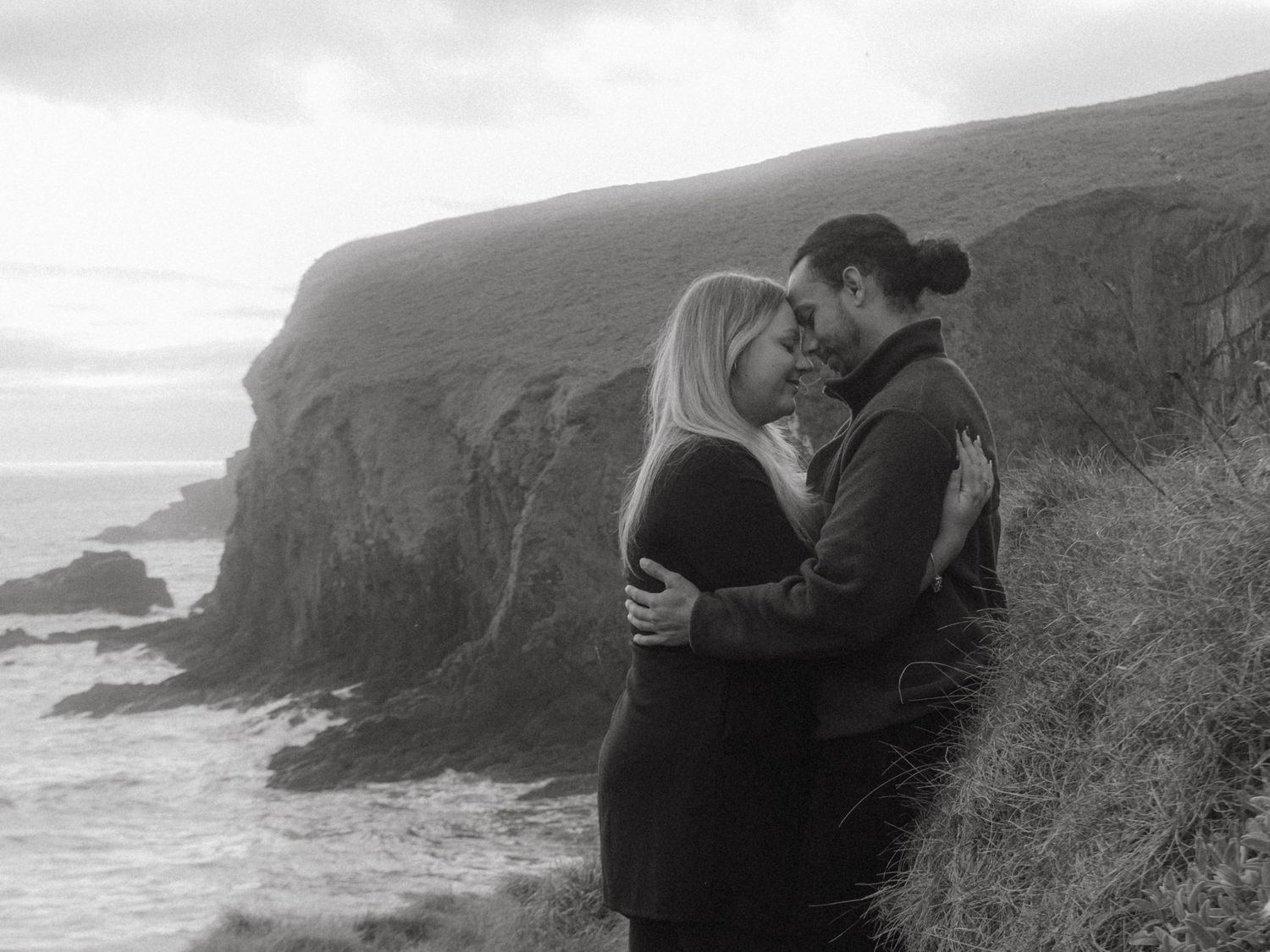 Photograph of couple posing at Nohoval Cove in Cork, Ireland.