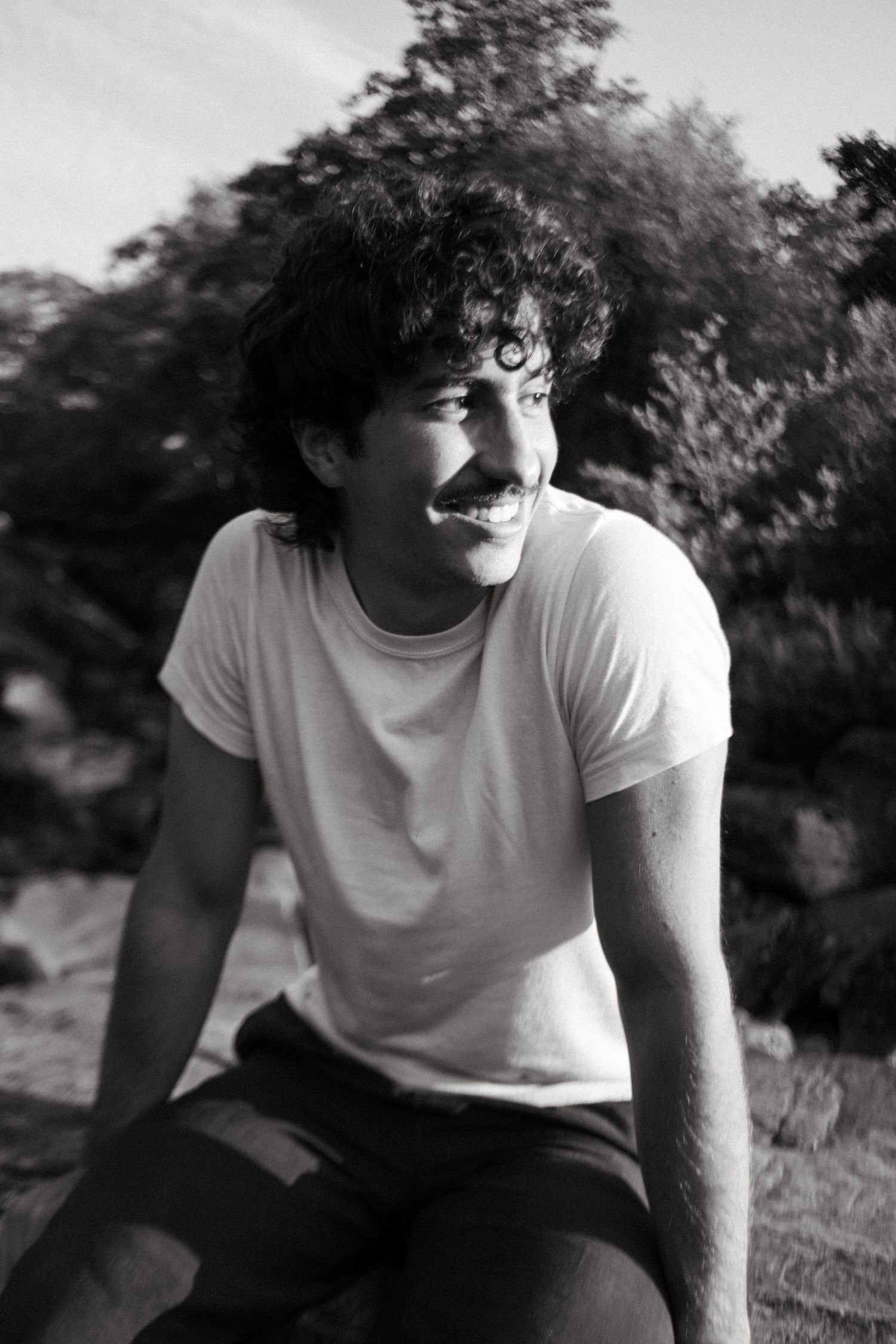 Black and white photograph of a young man in Irish rugged nature.