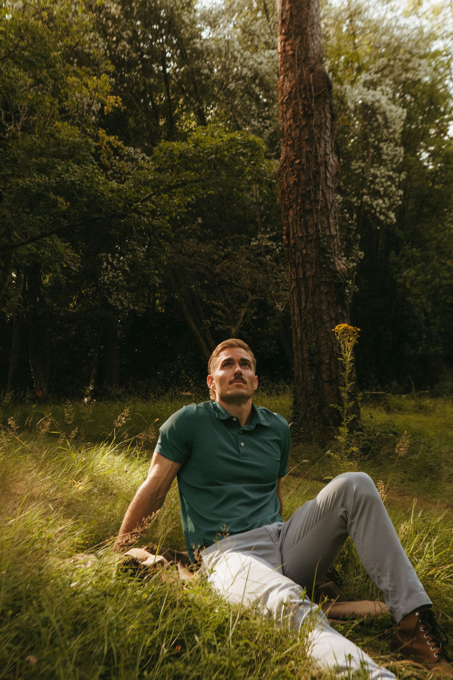 Portrait of young man in Killarney National Park, he has short blonde hair and a mustache.