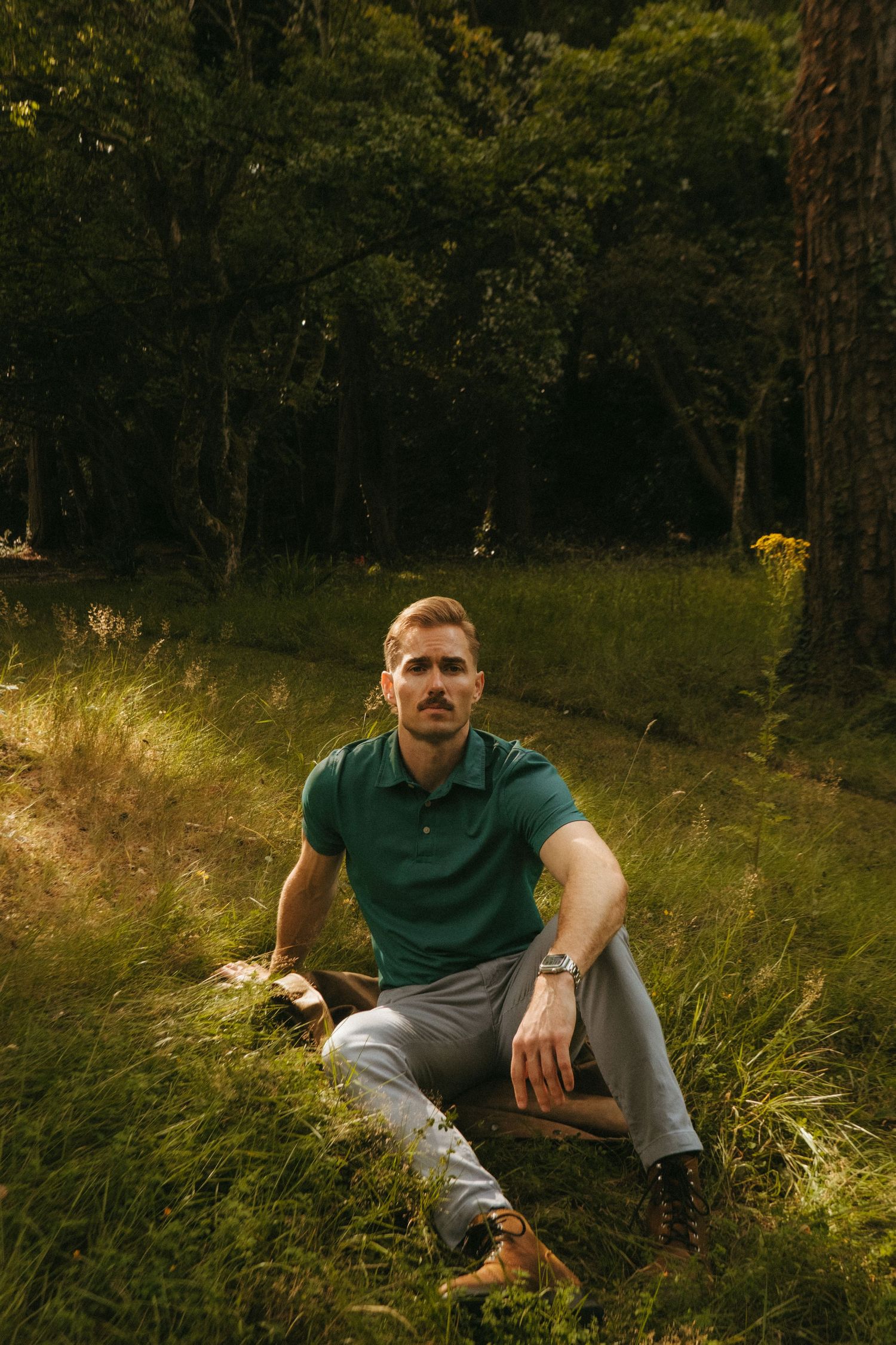 Portrait of young man in Killarney National Park, he has short blonde hair and a mustache.