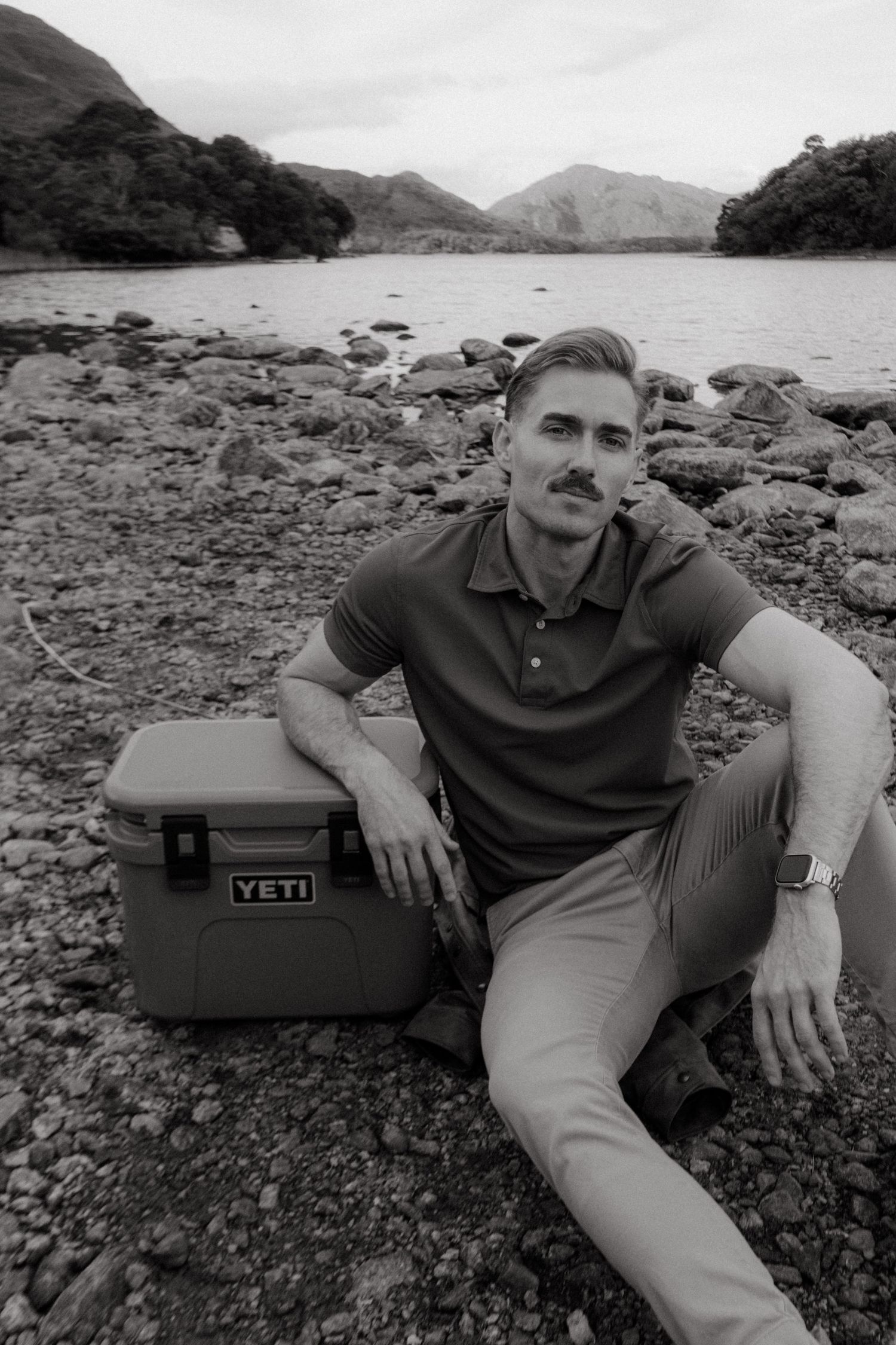 Portrait of young man in Killarney National Park, he has short blonde hair and a mustache.