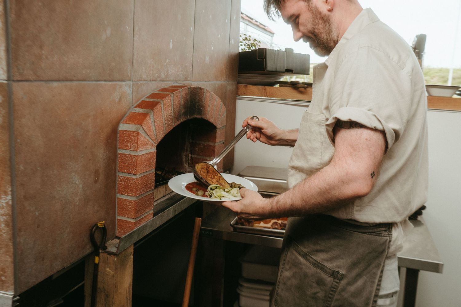 Photo of chef plating food.