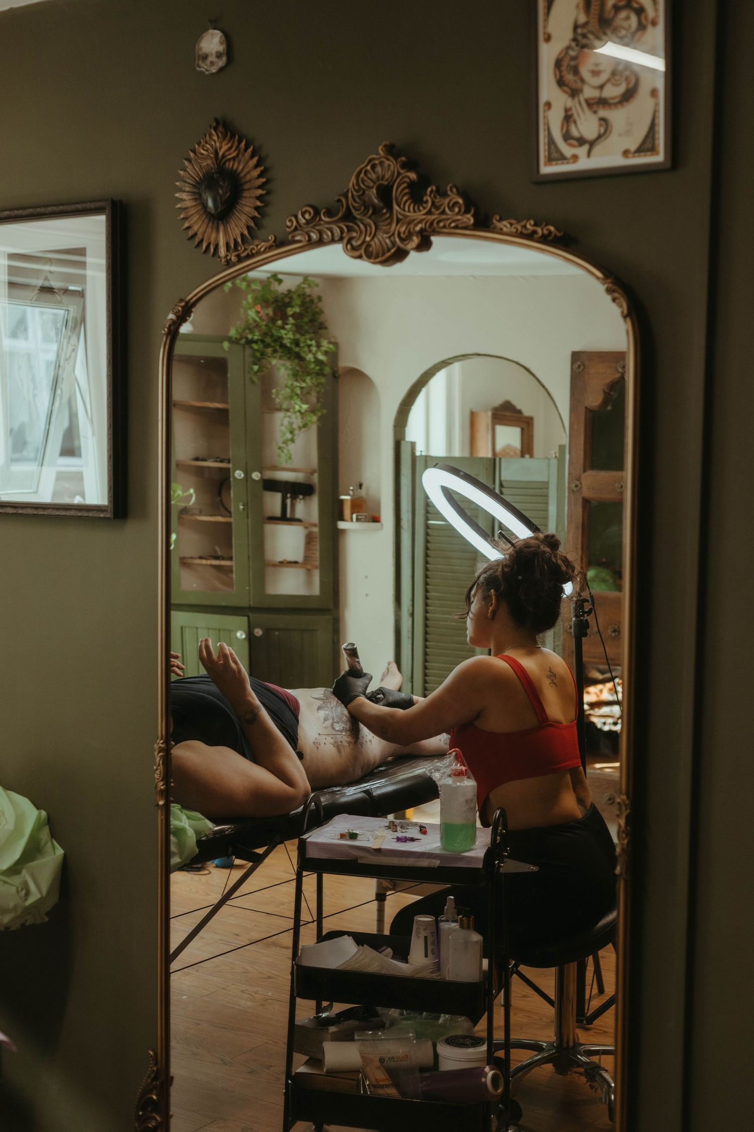 wide angle shot of tattoo artist working