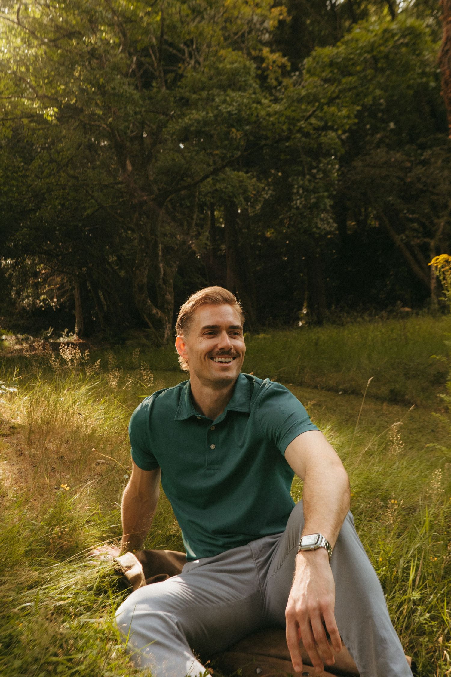 Portrait of young man in Killarney National Park, he has short blonde hair and a mustache.
