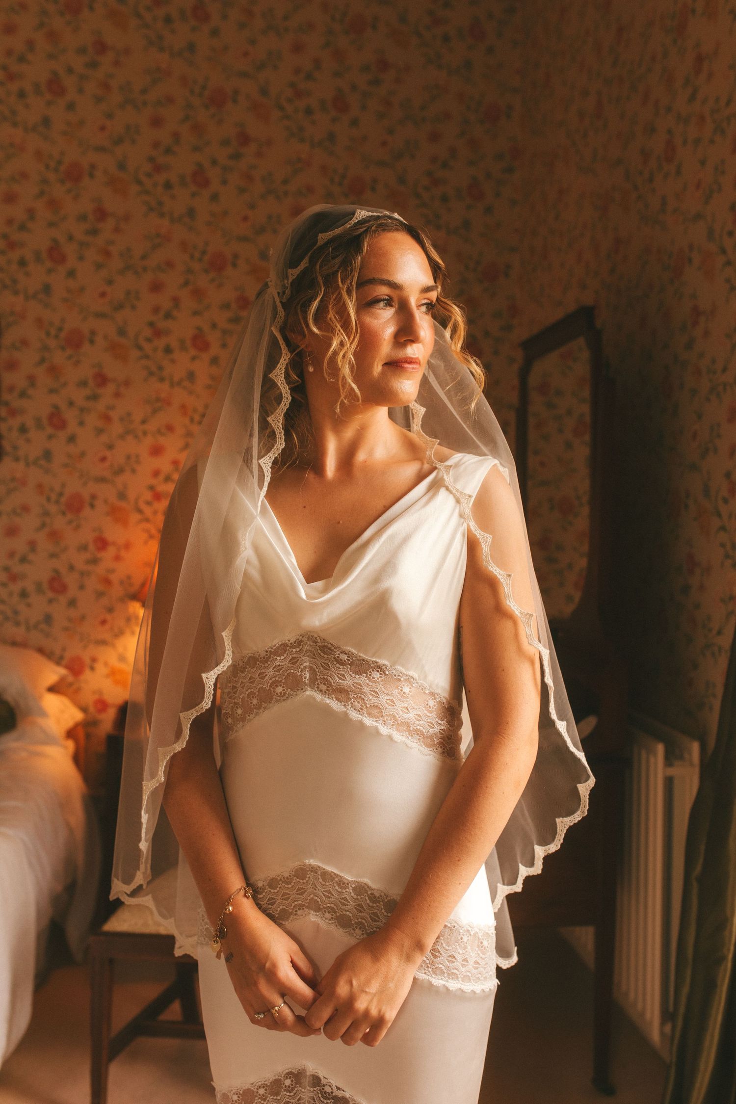 Photograph of bride in her wedding dress, she's looking to her left
