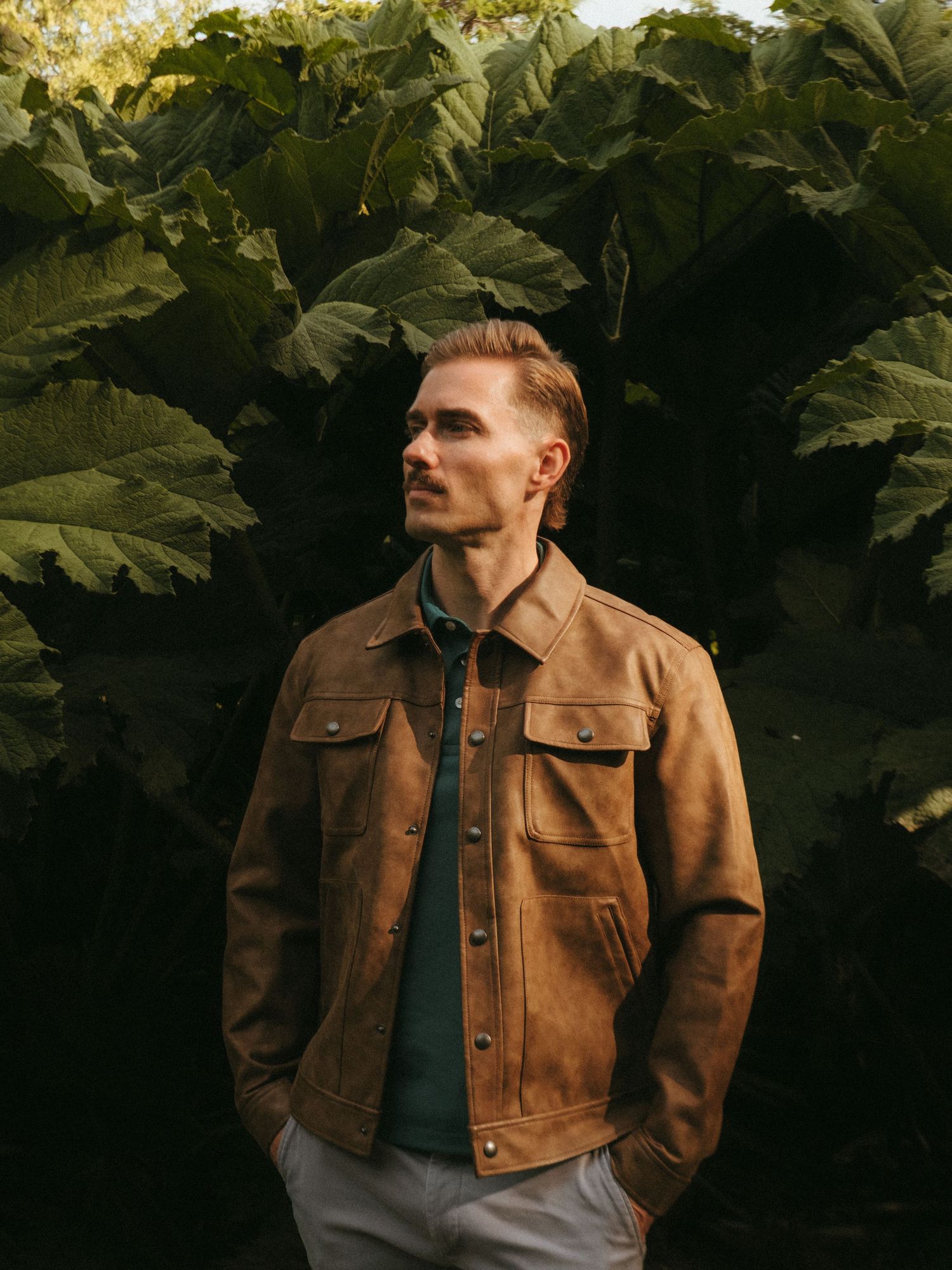 Portrait of young man in Killarney National Park, he has short blonde hair and a mustache.