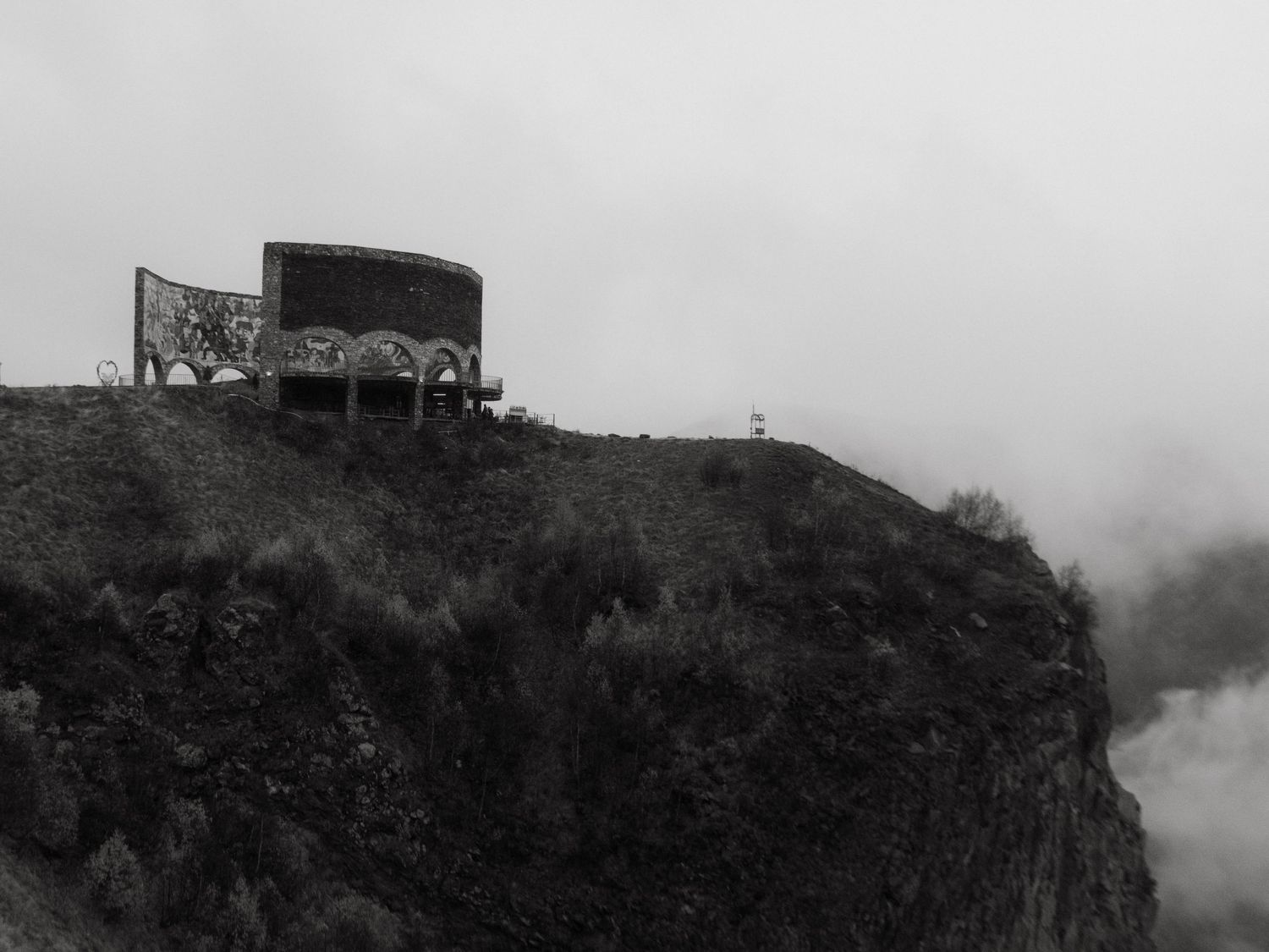 Black and white photograph of the Russian-georgian friendship monument in Georgia on a foggy day