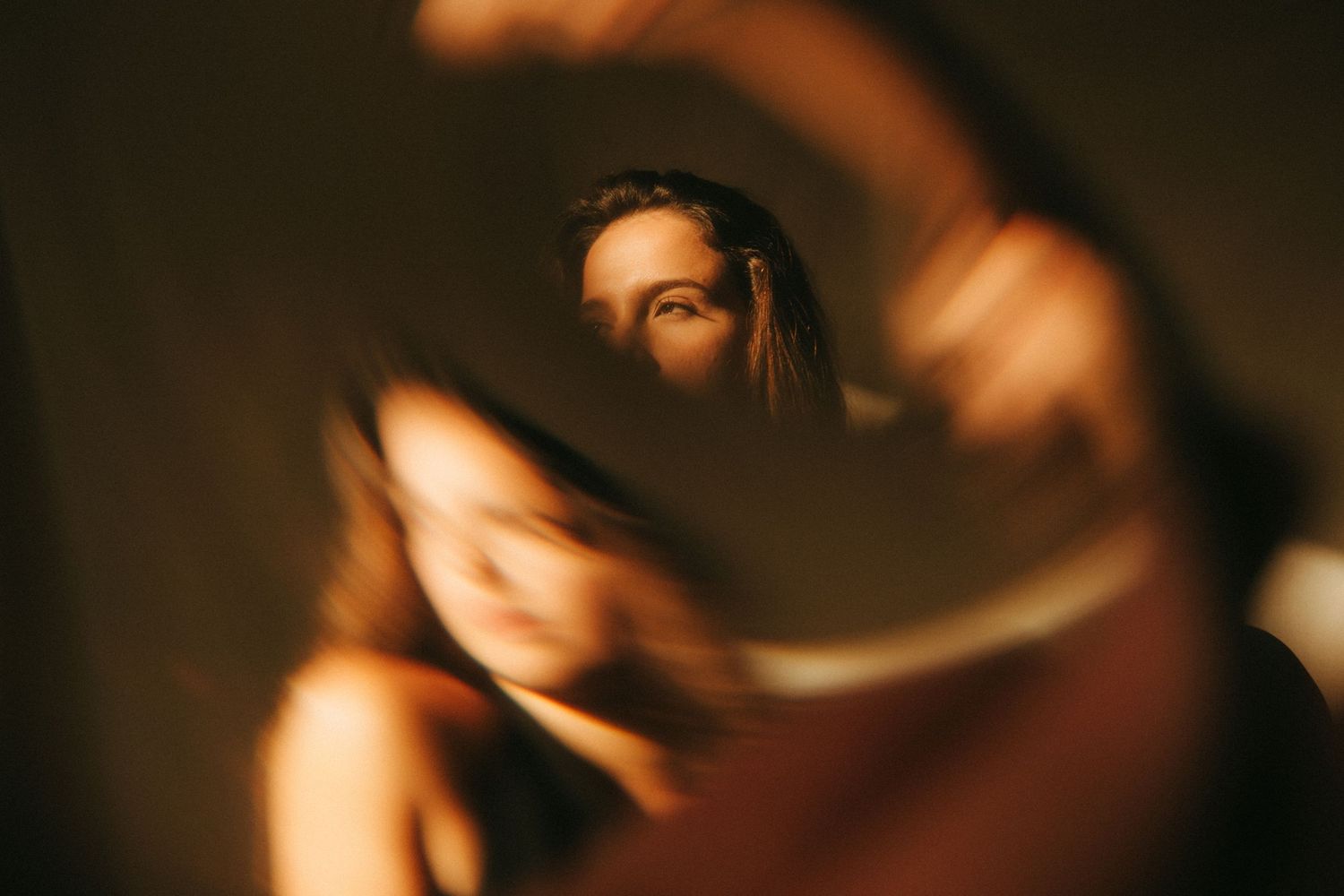 photograph of a dark haired model in a studio setting, soft contrast.