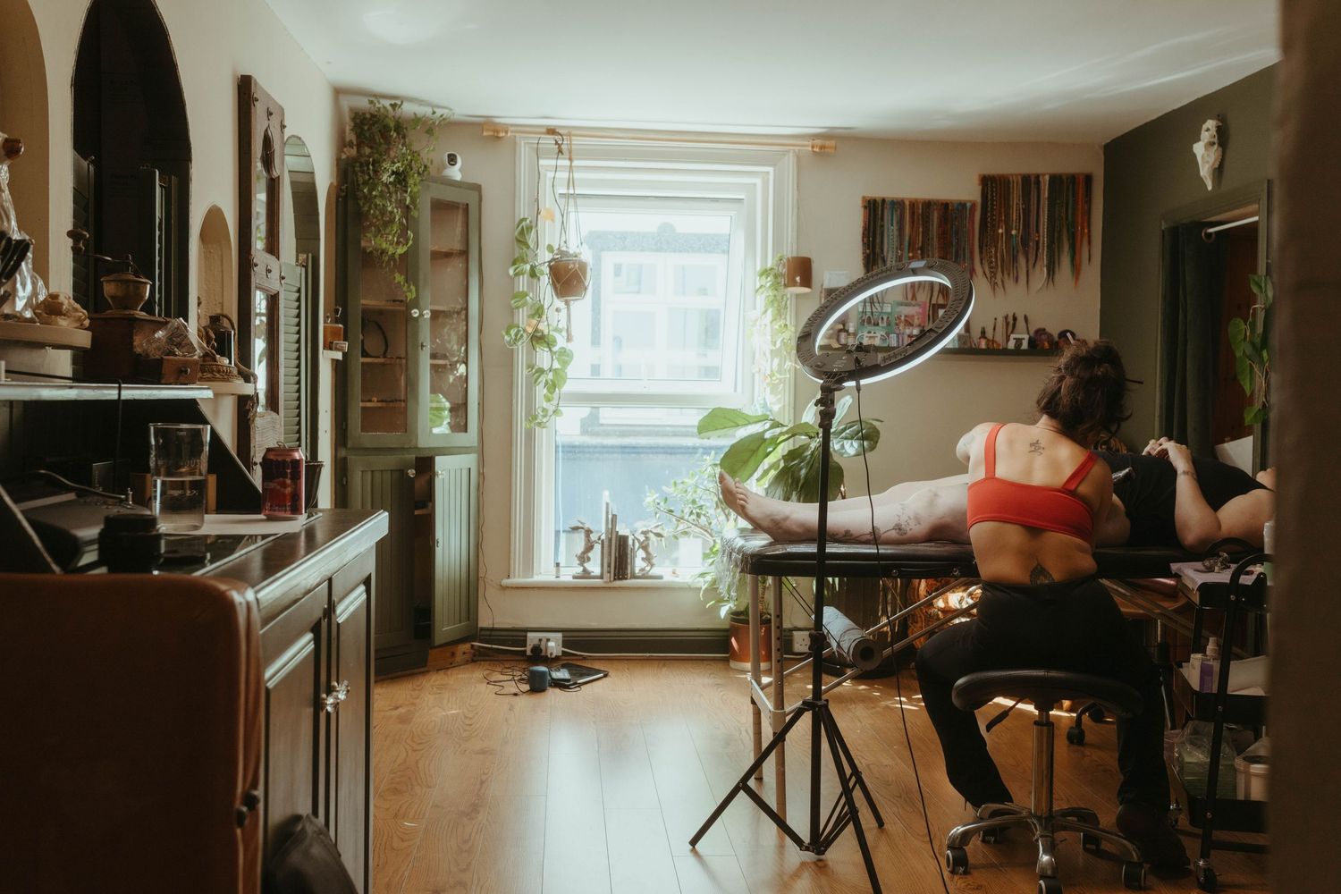 wide angle shot of tattoo artist working
