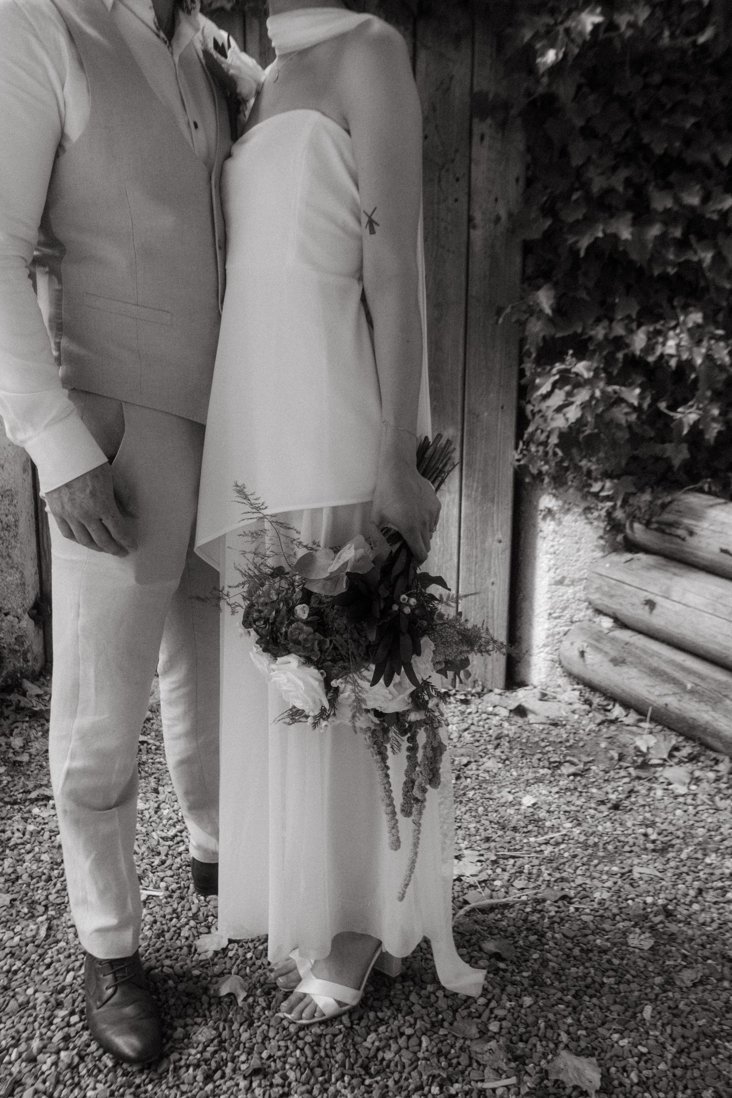Photograph of bride and groom, she has dark brown hair and he is bald with a ginger beard.
