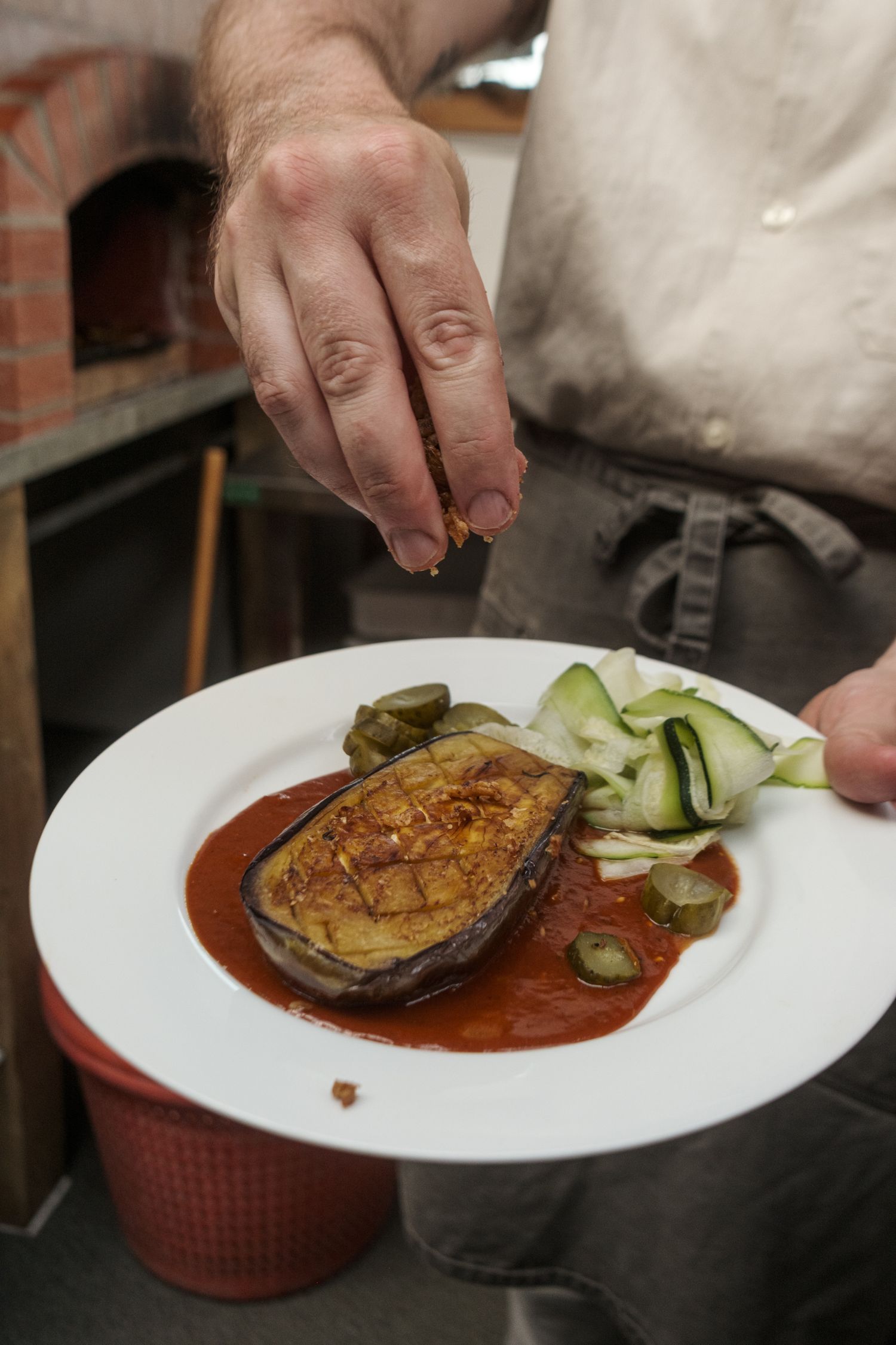 Close up of chef garnishing dish