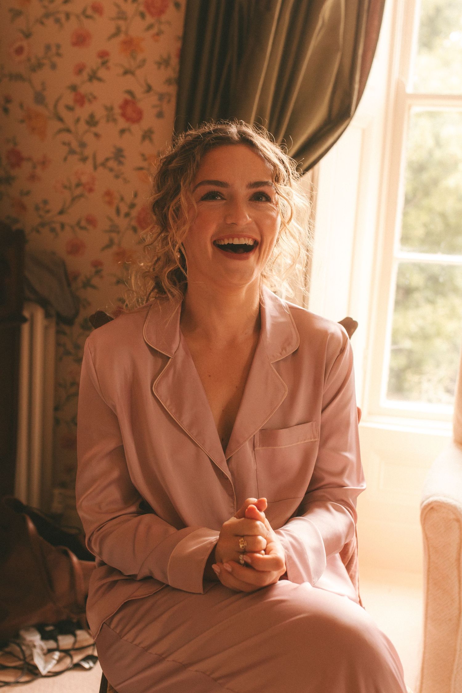 Photograph of bride during getting ready, she's laughing