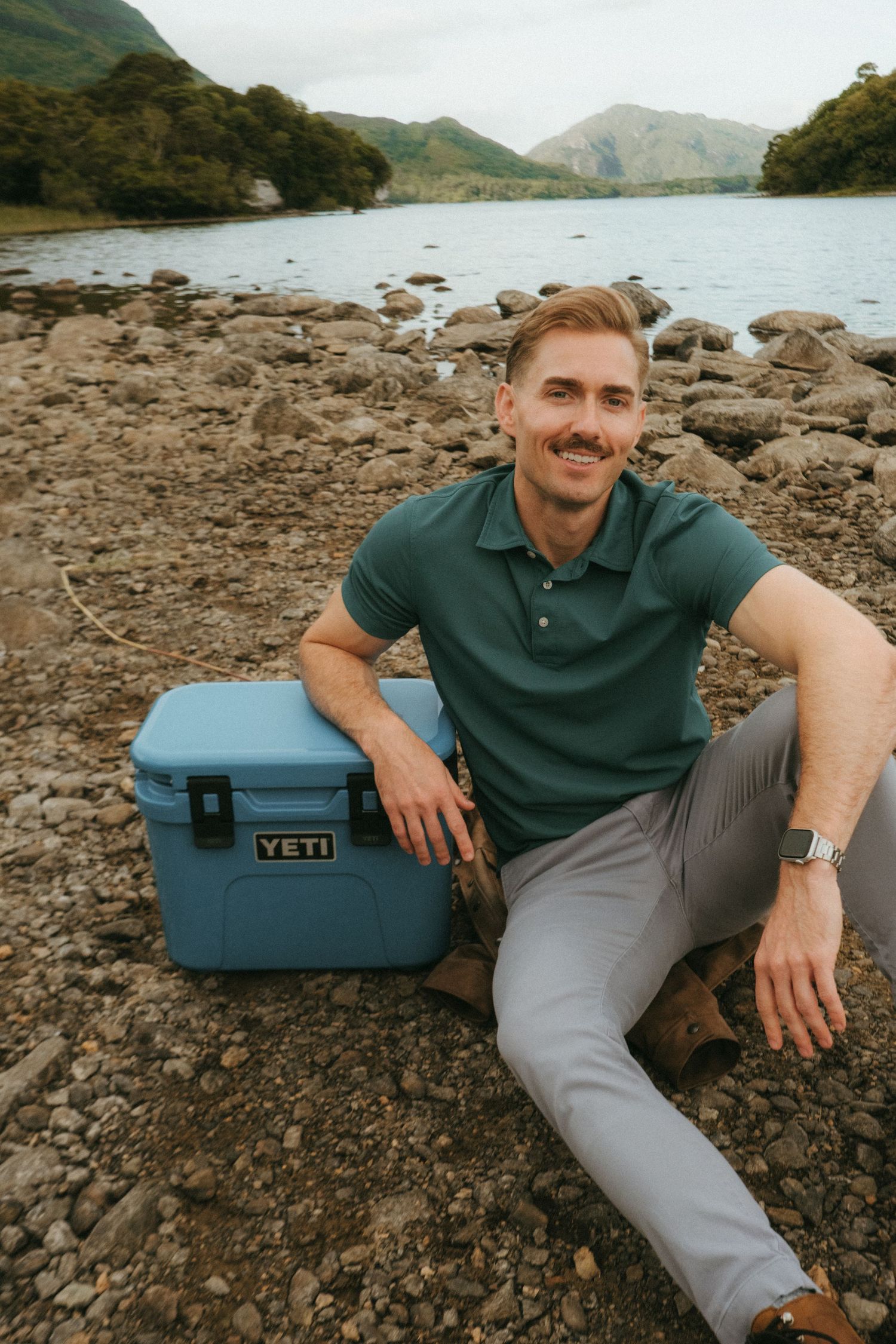Portrait of young man in Killarney National Park, he has short blonde hair and a mustache.
