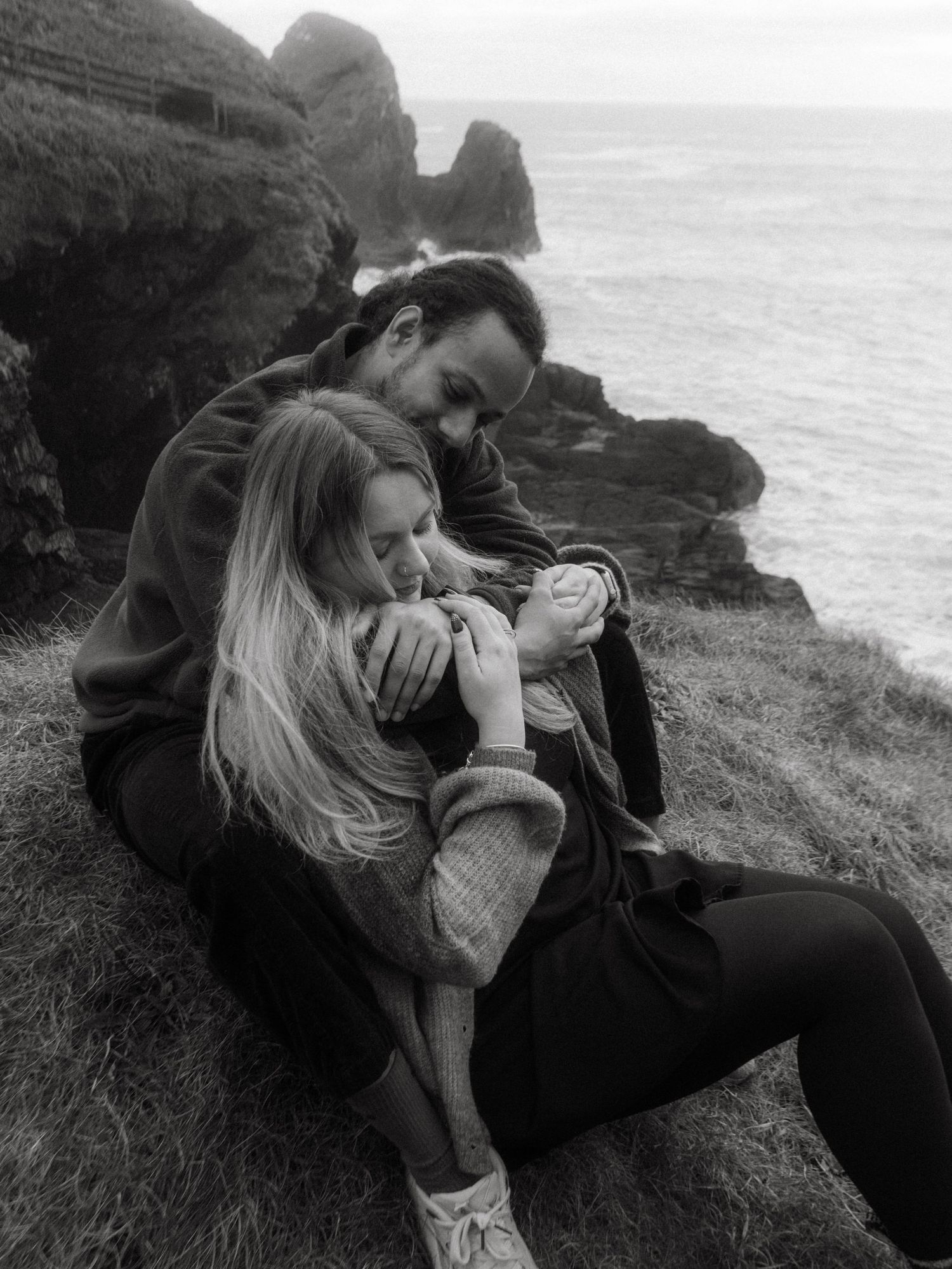 Photograph of couple posing at Nohoval Cove in Cork, Ireland.