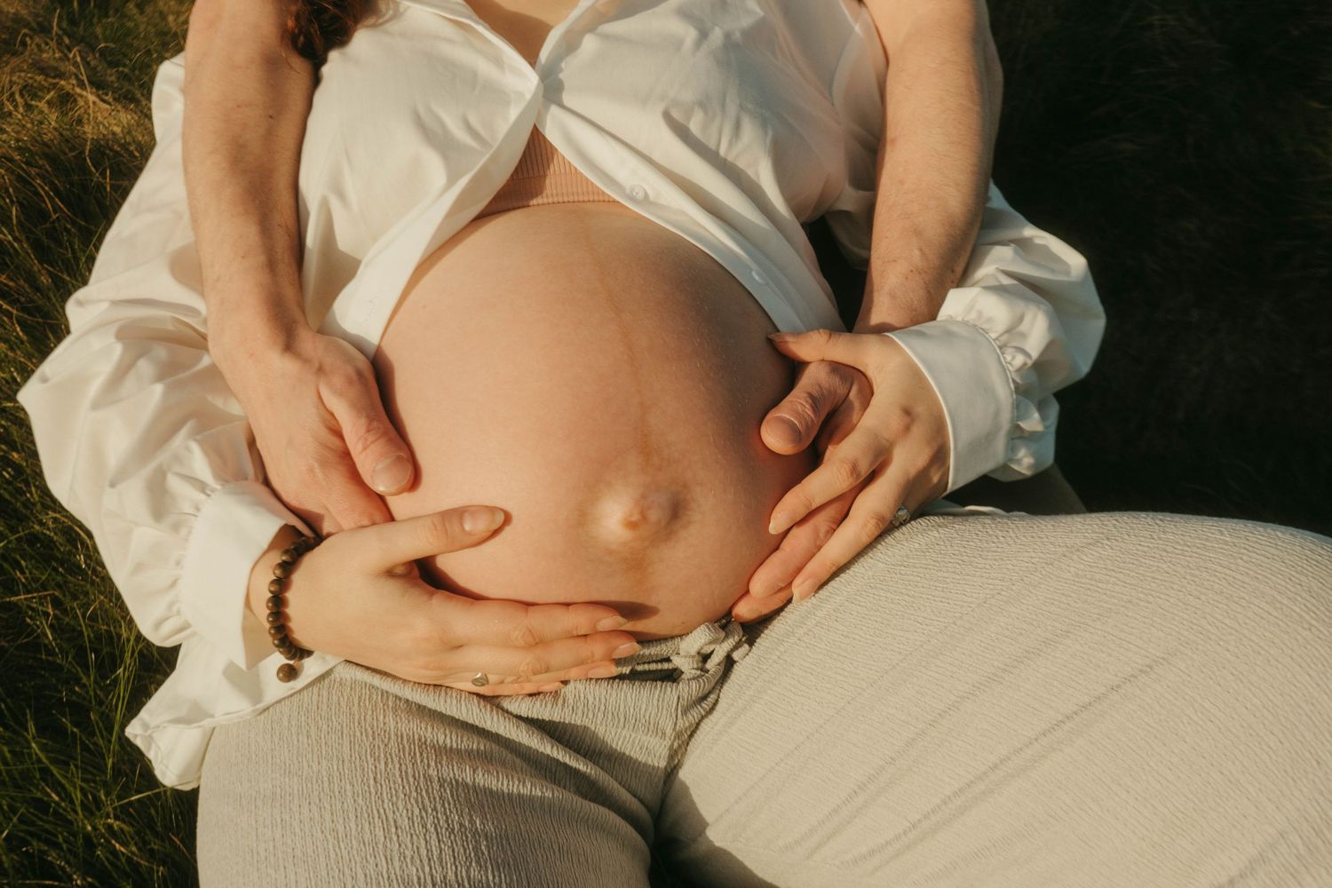 Photograph of couple, holding her belly