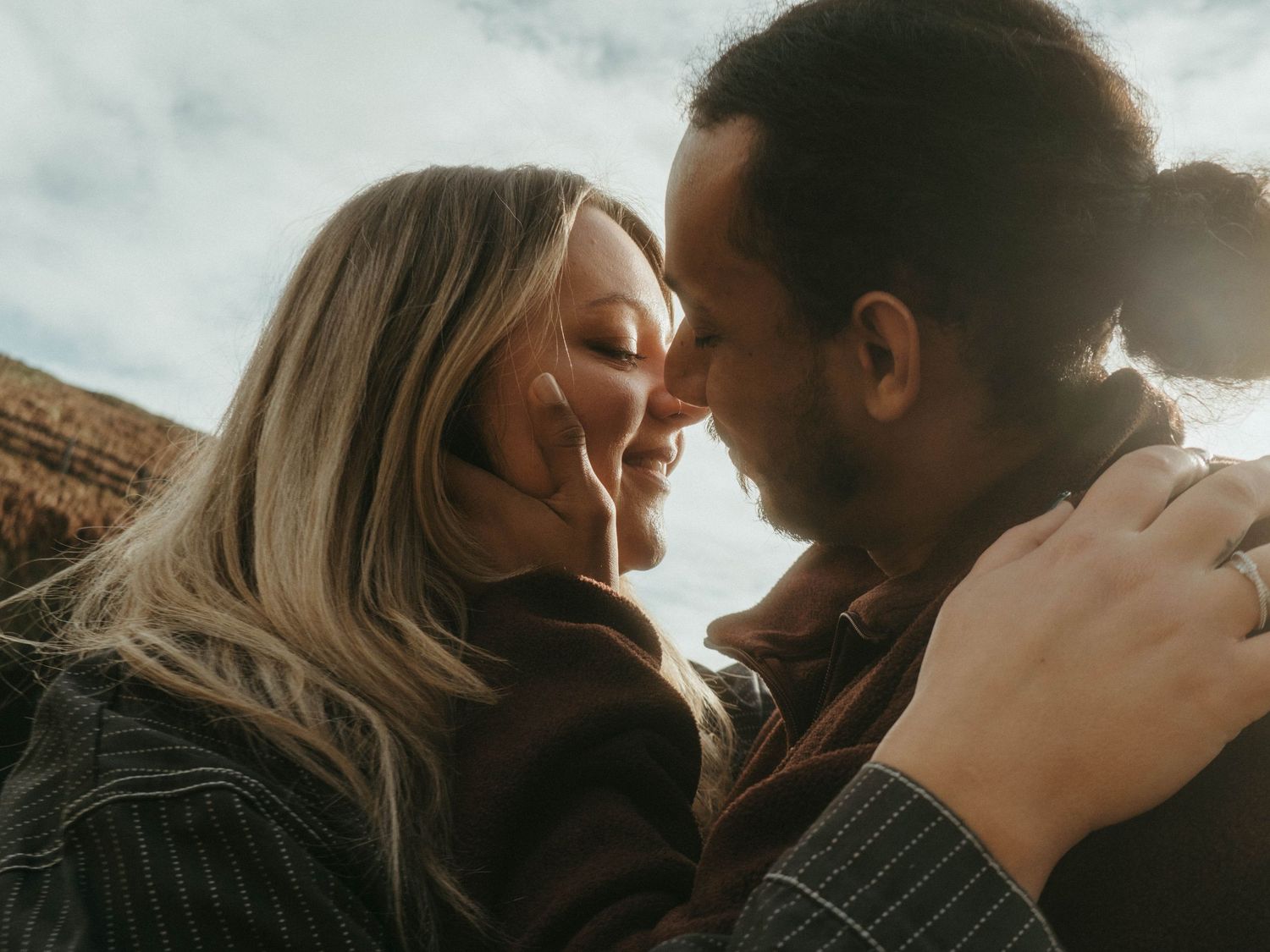 Photograph of couple posing at Nohoval Cove in Cork, Ireland. Soft contrast, warm colors.