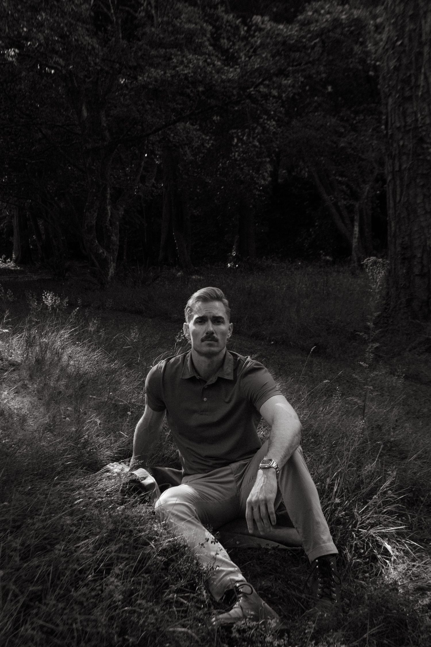 Portrait of young man in Killarney National Park, he has short blonde hair and a mustache.