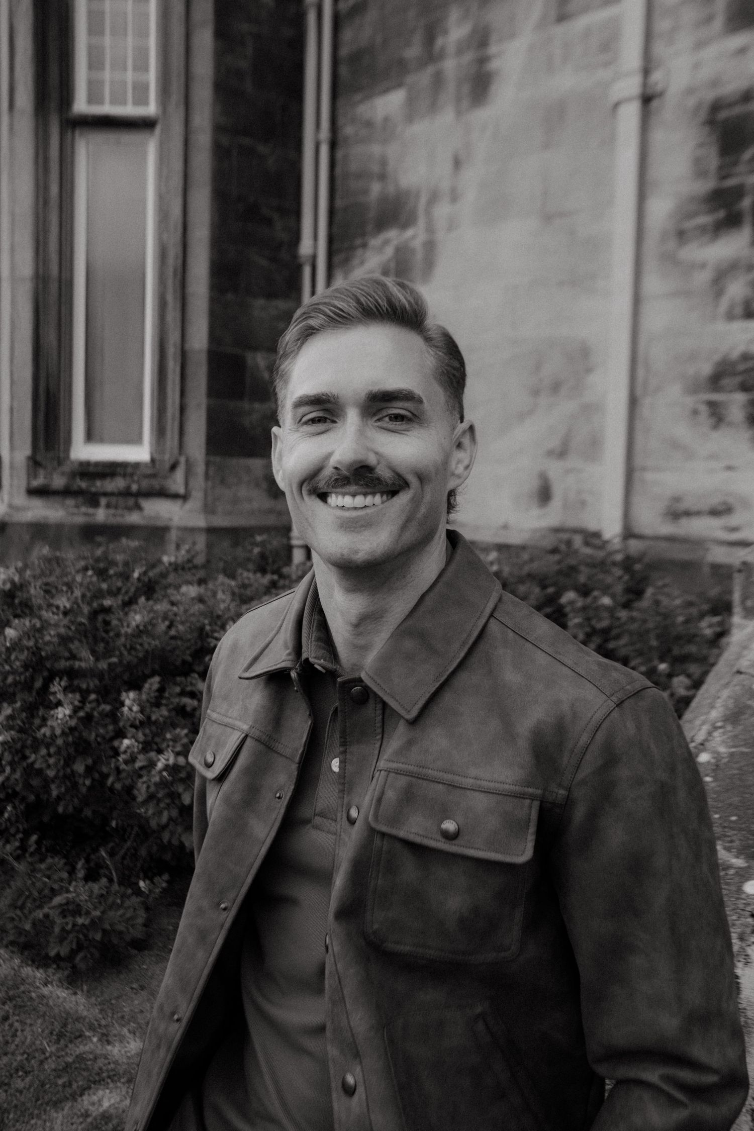 Portrait of young man in Killarney National Park, he has short blonde hair and a mustache.