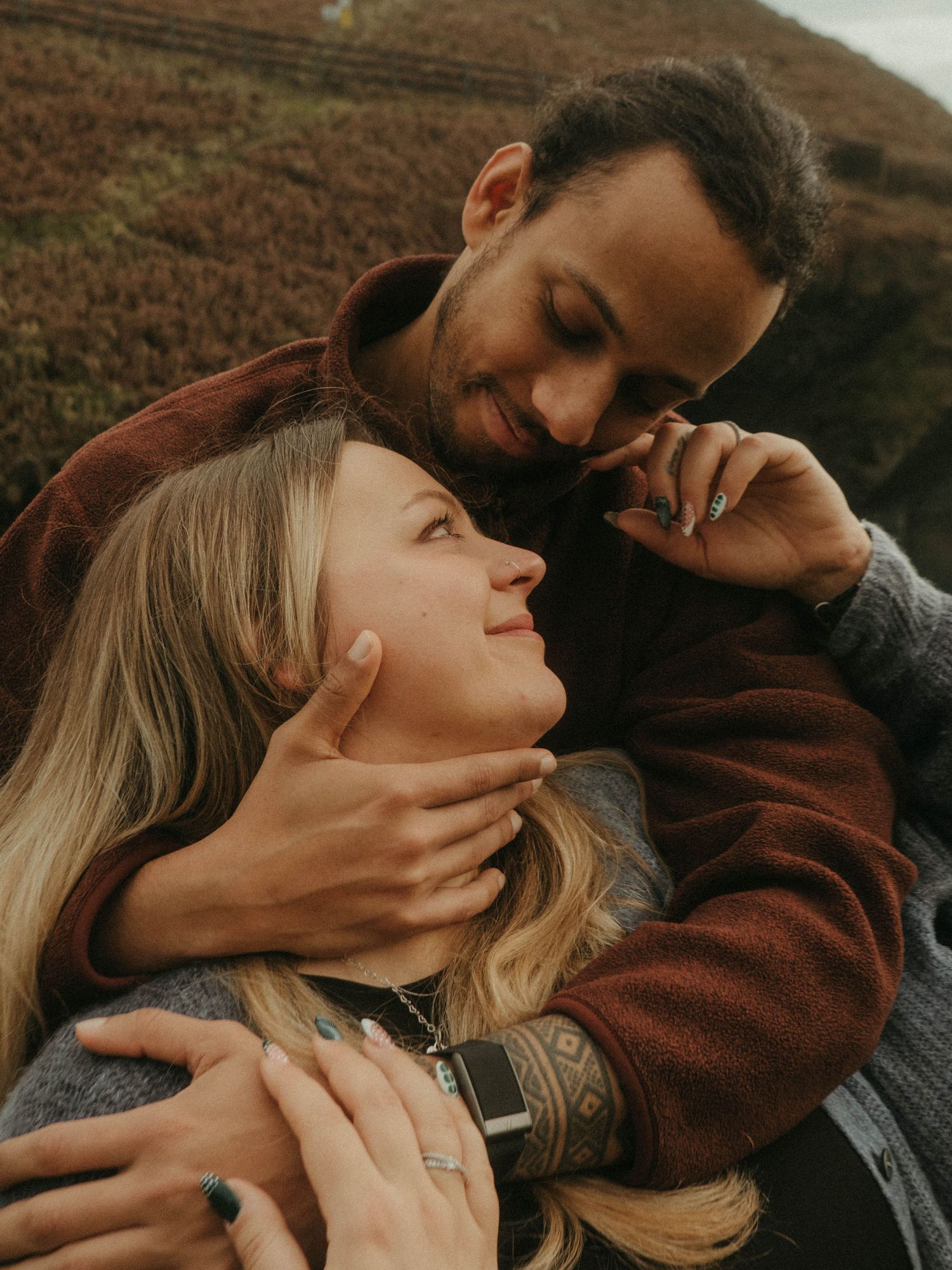 Photograph of couple posing at Nohoval Cove in Cork, Ireland. Soft contrast, warm colors.