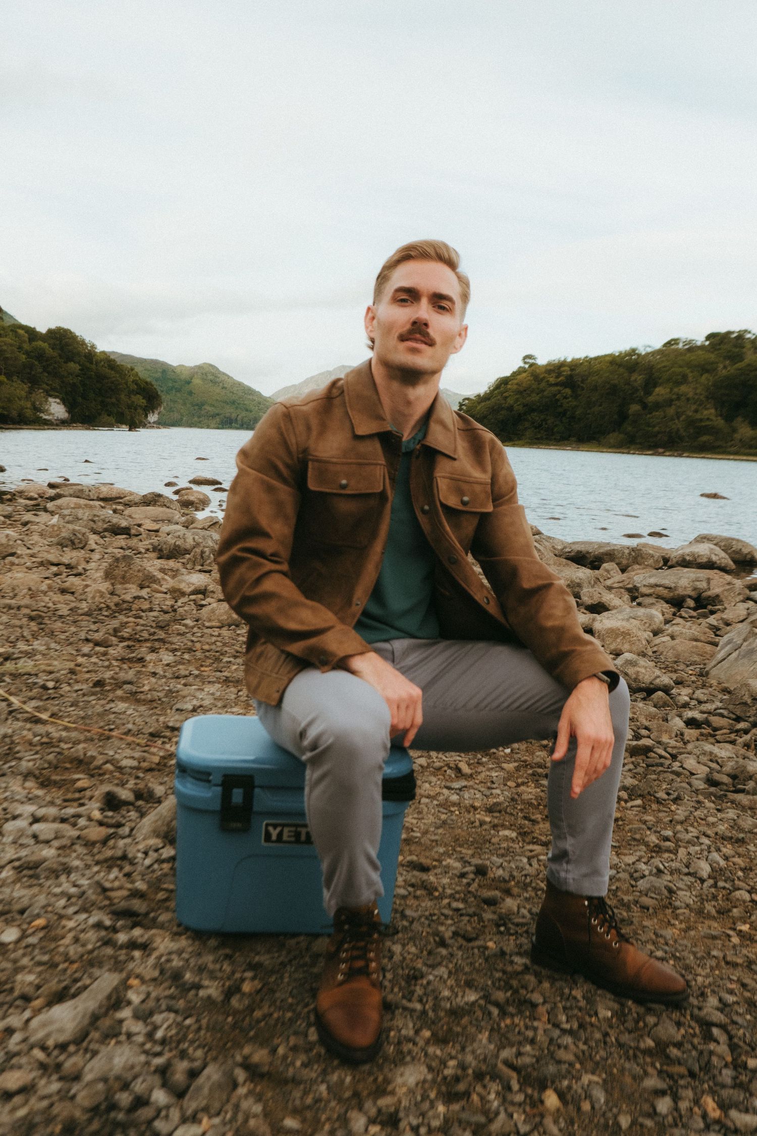 Portrait of young man in Killarney National Park, he has short blonde hair and a mustache.
