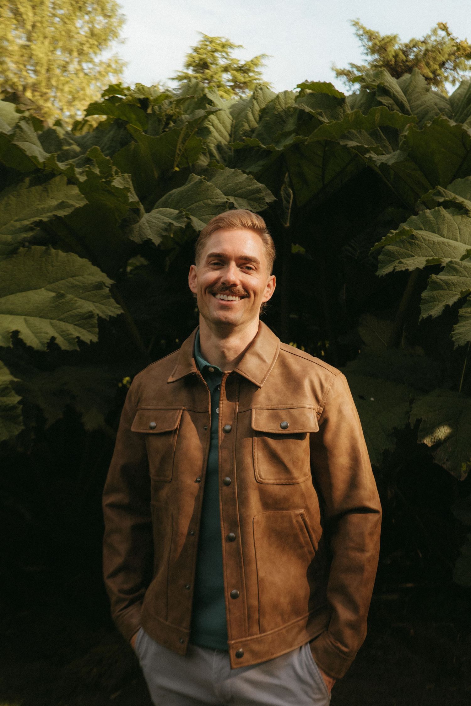 Portrait of young man in Killarney National Park, he has short blonde hair and a mustache.