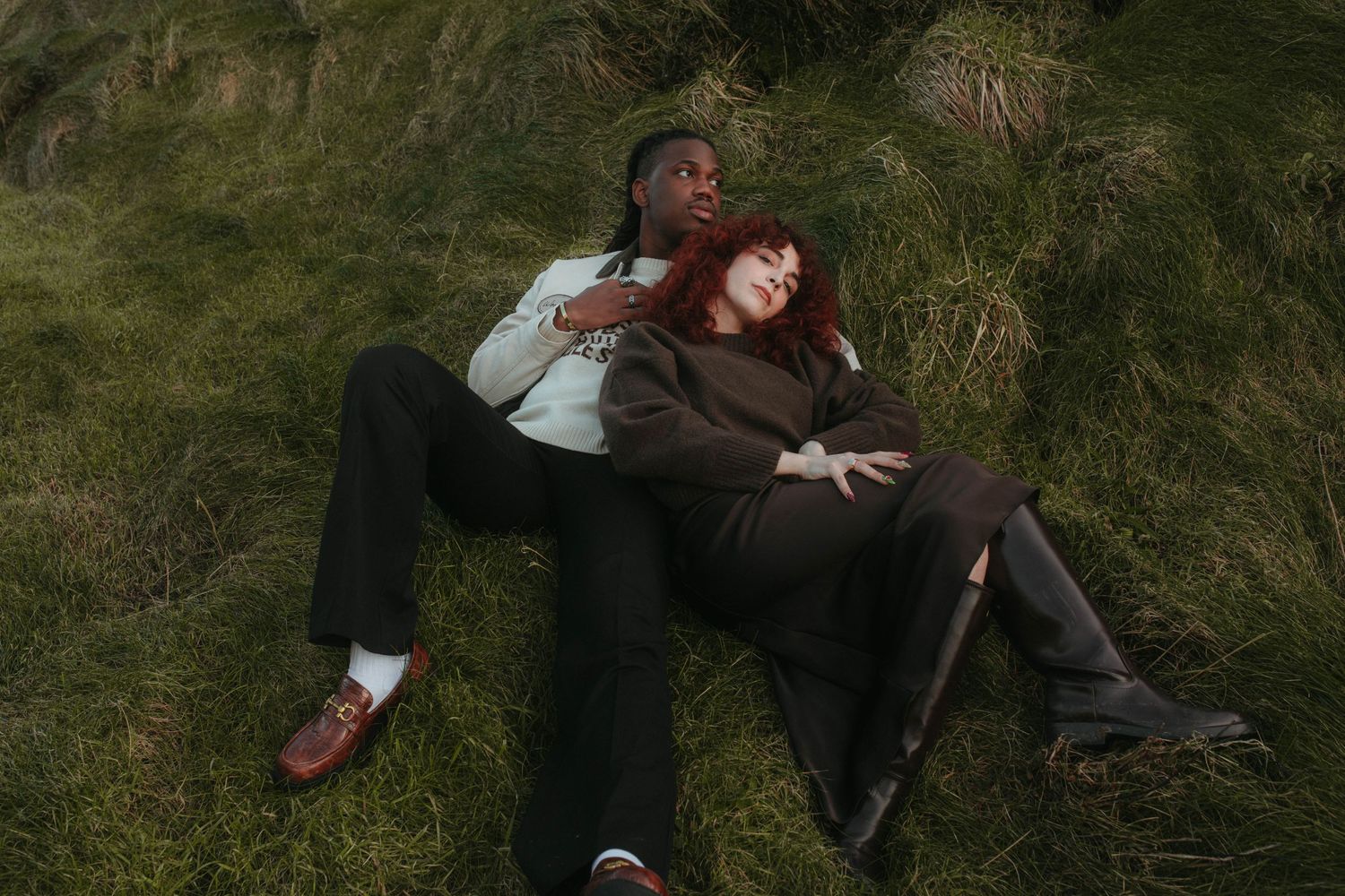 Photograph of couple laying in tall grass