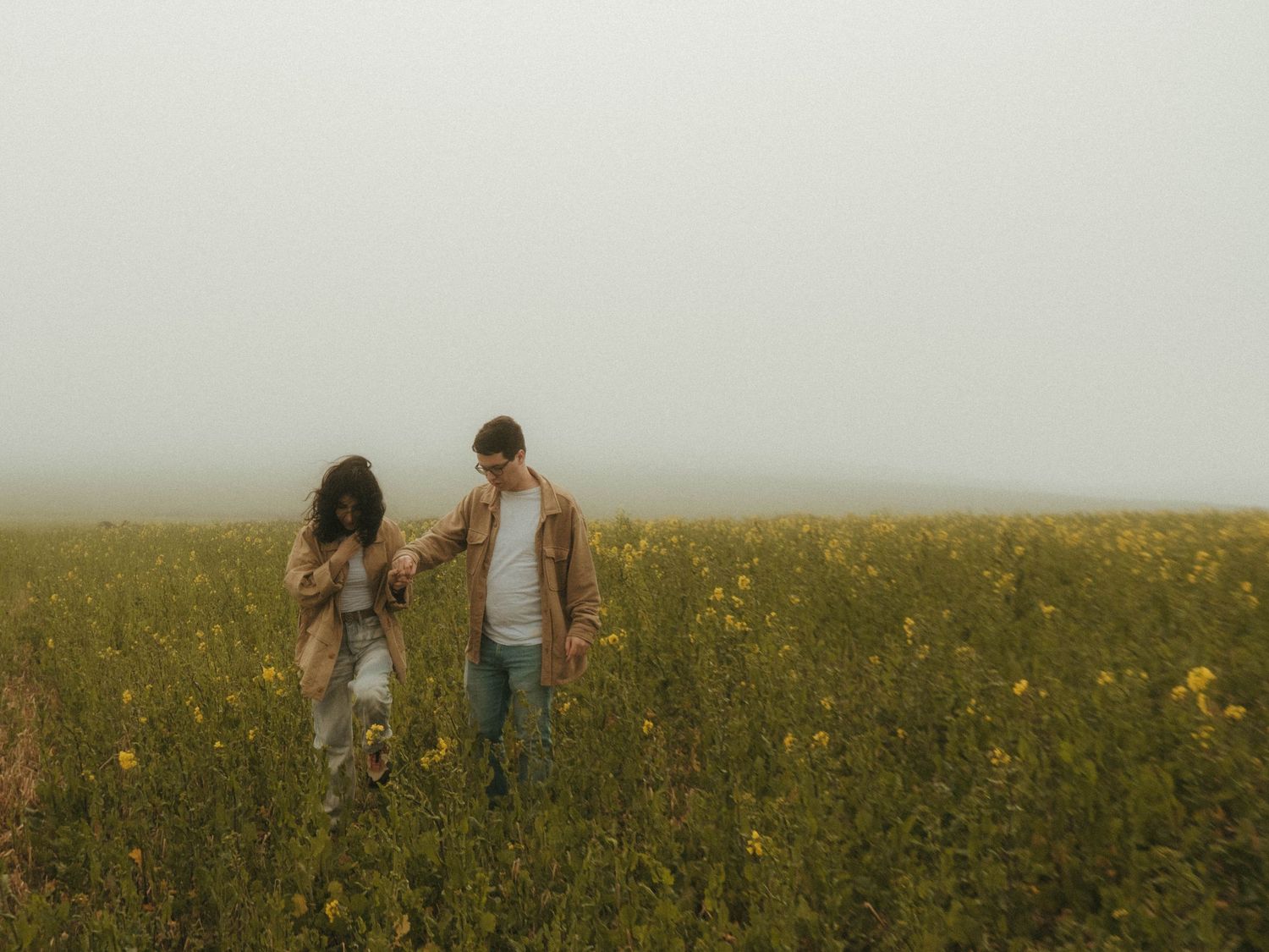 photograph of couple in a canola field
