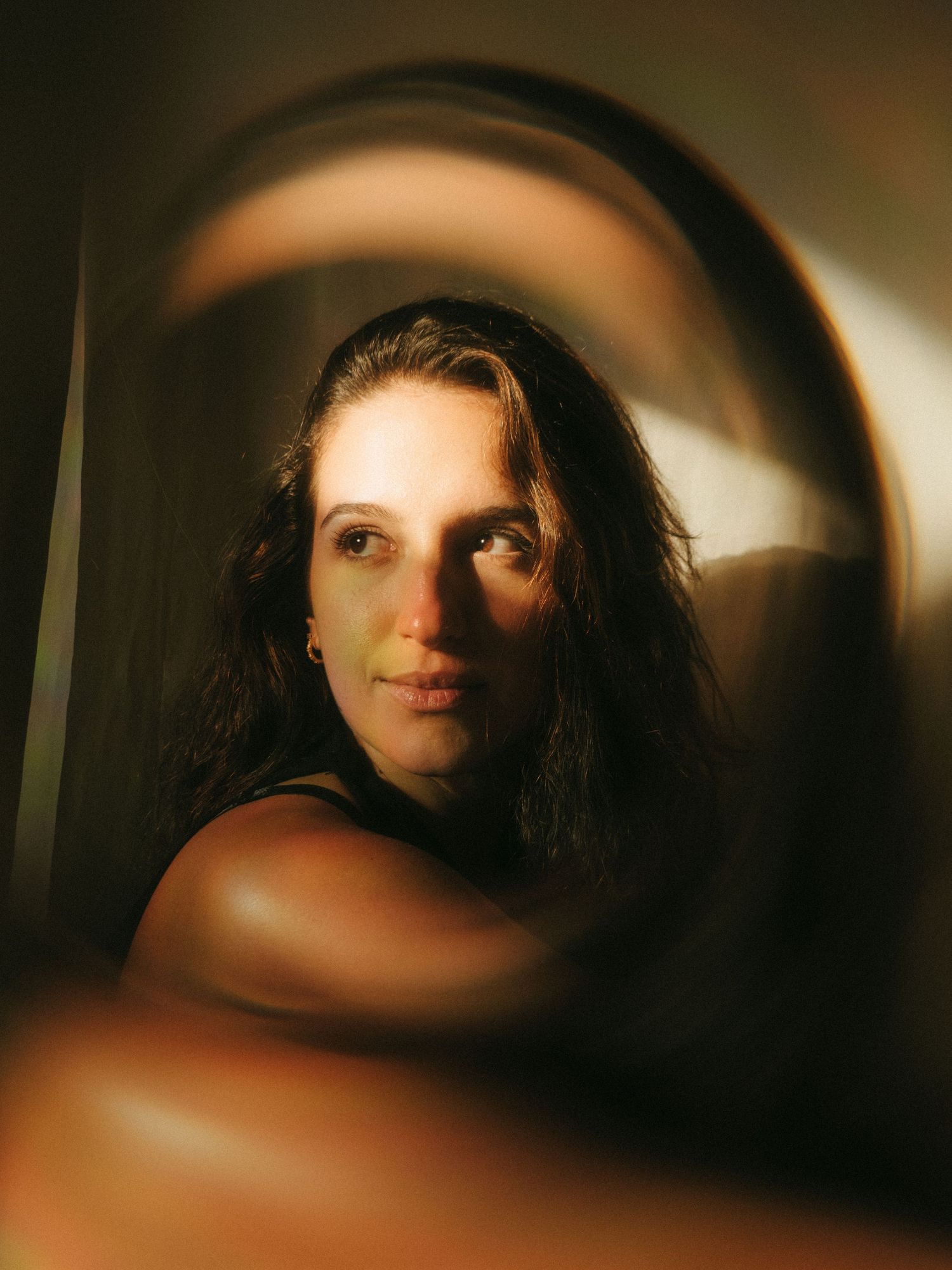 photograph of a dark haired model in a studio setting, soft contrast.