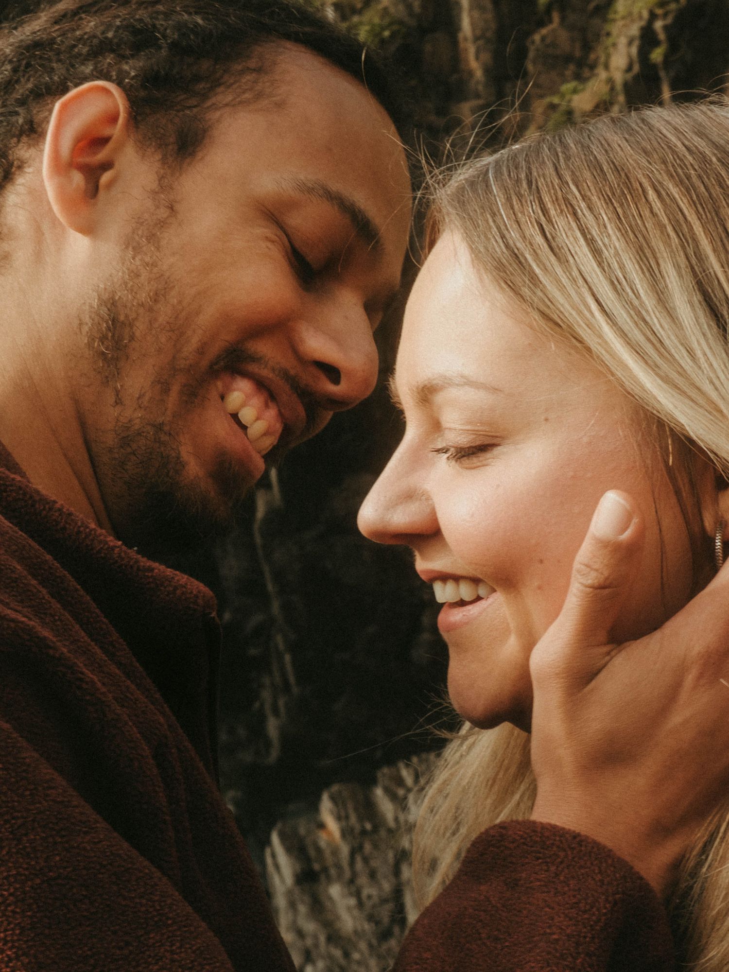 Photograph of couple posing at Nohoval Cove in Cork, Ireland. Soft contrast, warm colors.