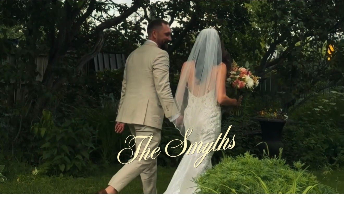 Bride and groom walk hand in hand through garden with The Smiths wedding title overlay.