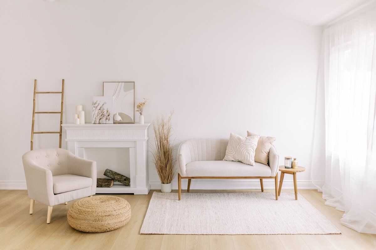 Minimalist white interior room design with natural light and beige accents showcasing Scandinavian style furniture. Studio Verde Hamilton