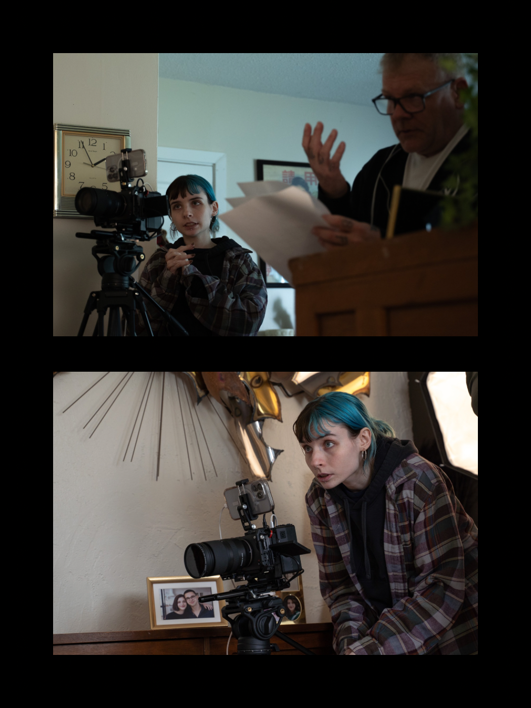 Young female cinematographer with teal hair operates a camera while an older man reviews script on a film set.