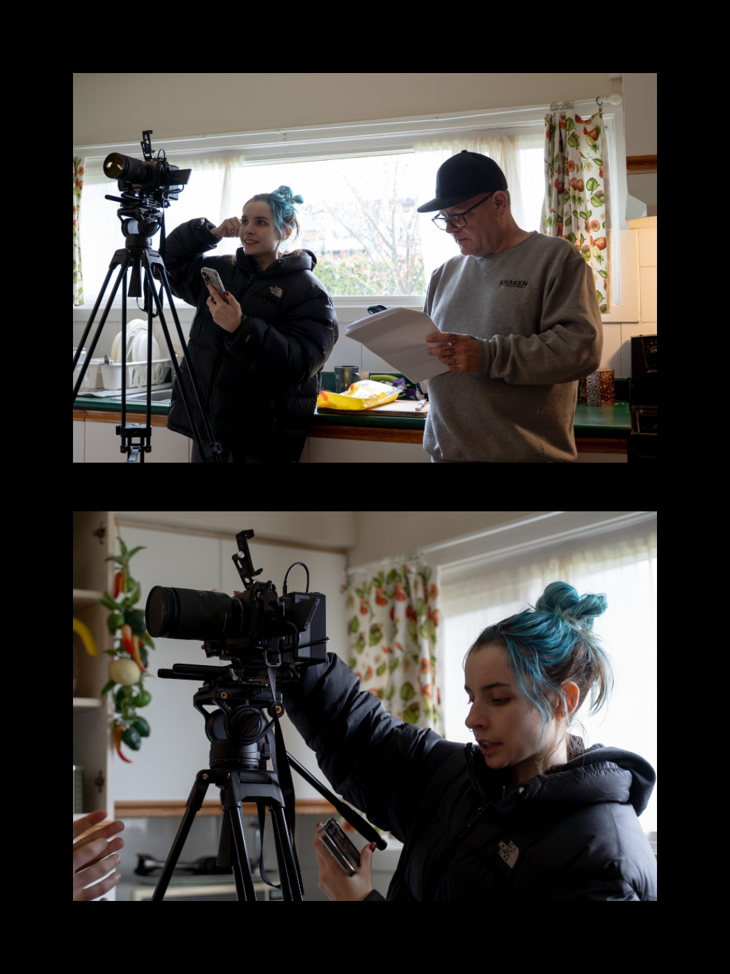 Woman with teal hair adjusting a camera on tripod while a man reviews script in a home kitchen.