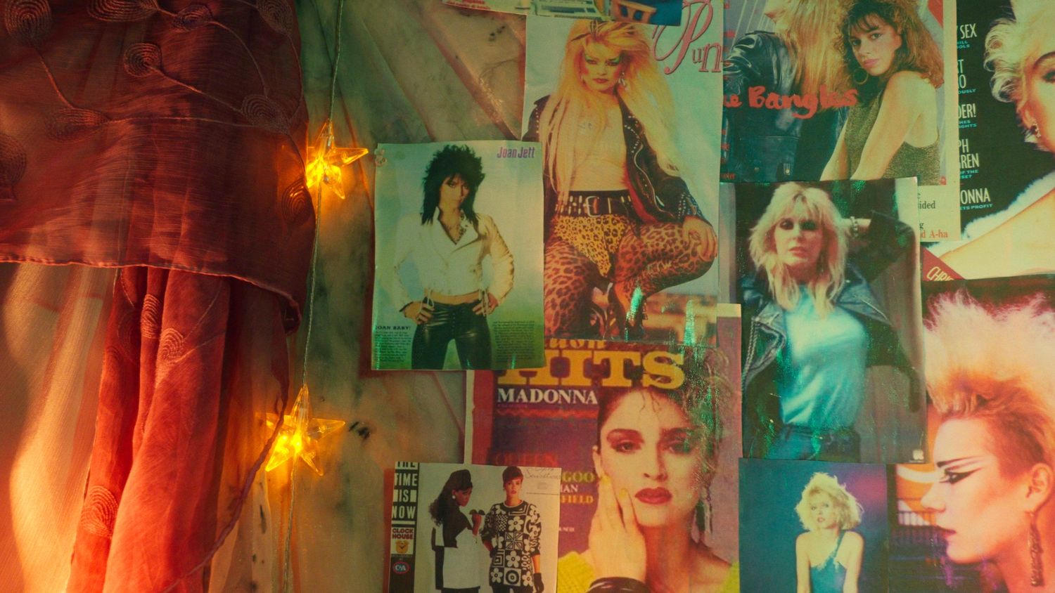 Retro wall collage featuring Madonna album covers and vintage pop culture posters.