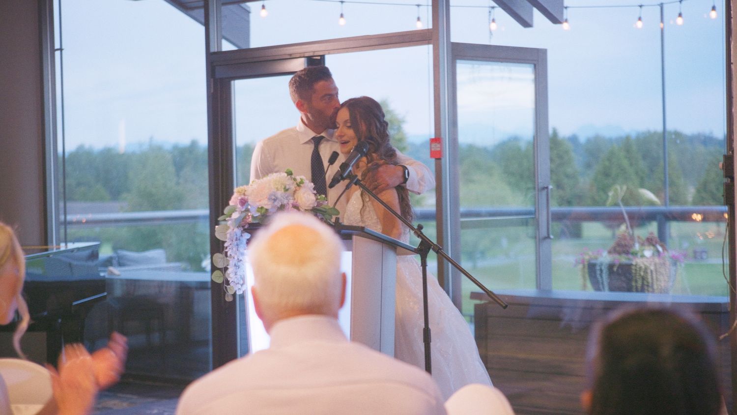 Bride and groom sharing a romantic moment at the altar during their wedding ceremony in an elegant venue.