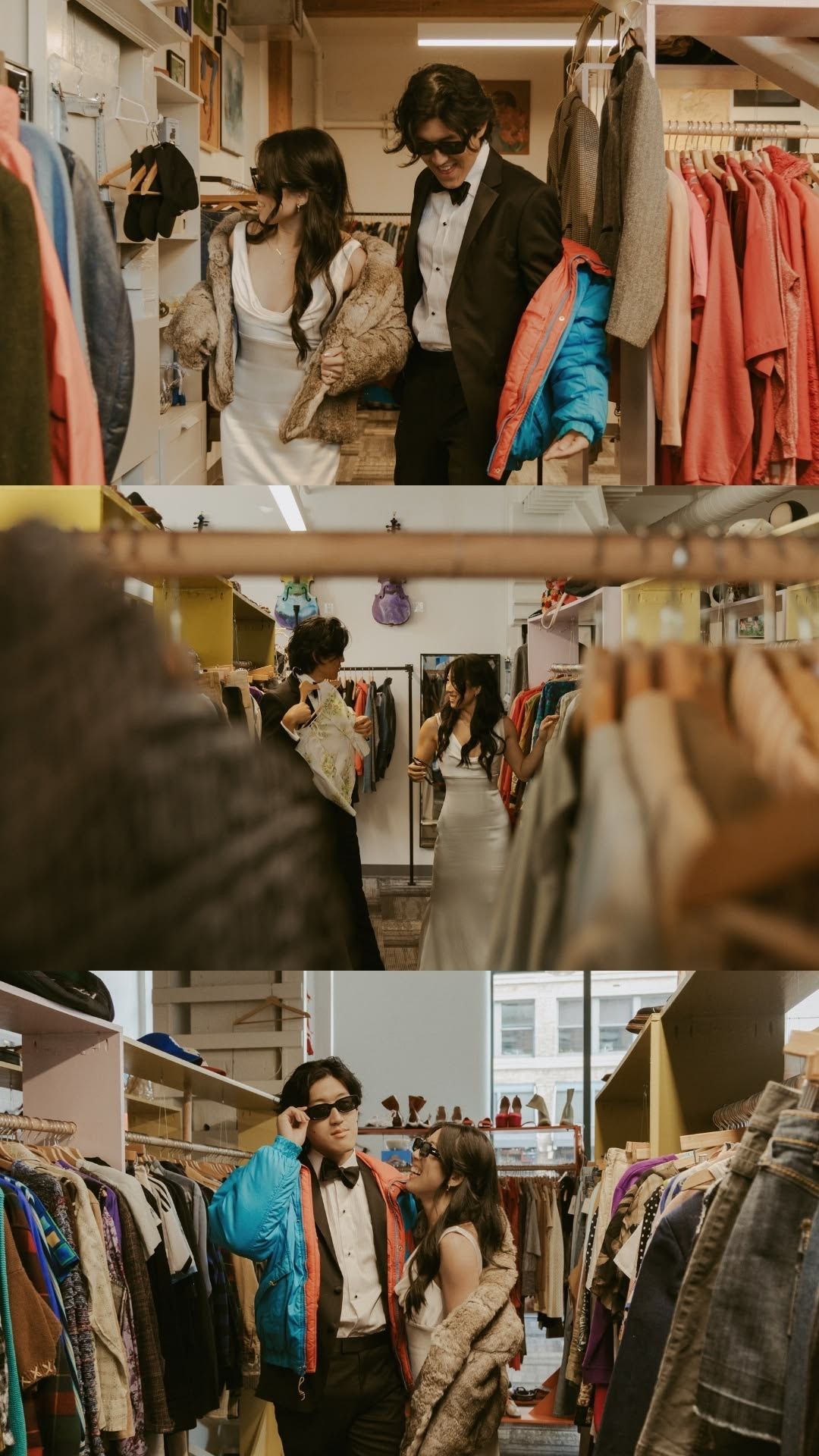 Couple shopping for vintage clothing in a thrift store, wearing stylish outfits and sunglasses among racks of colorful garments.