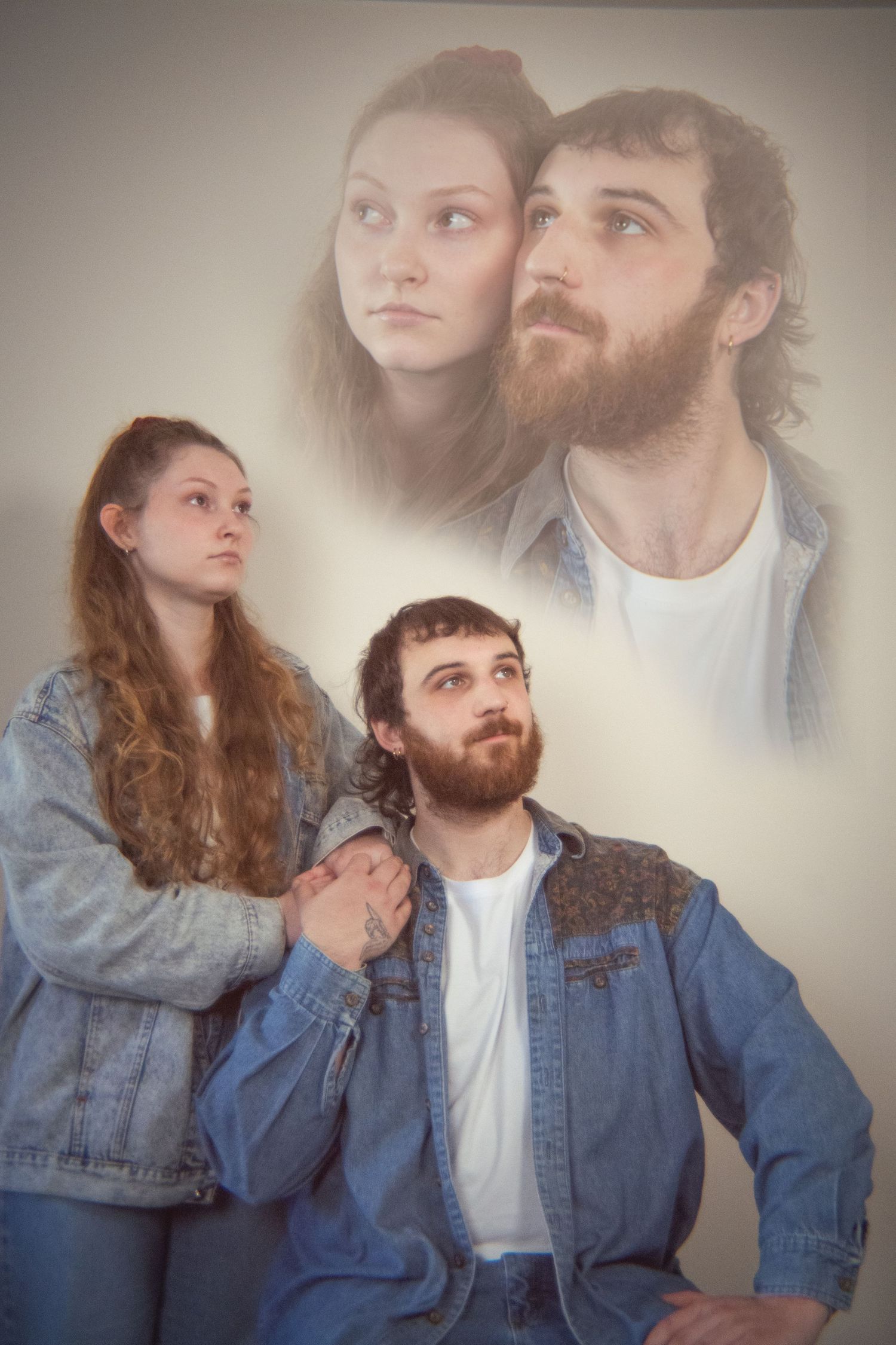 Creative double exposure portrait of a young couple in denim, with a dreamy faded image of their faces above.
