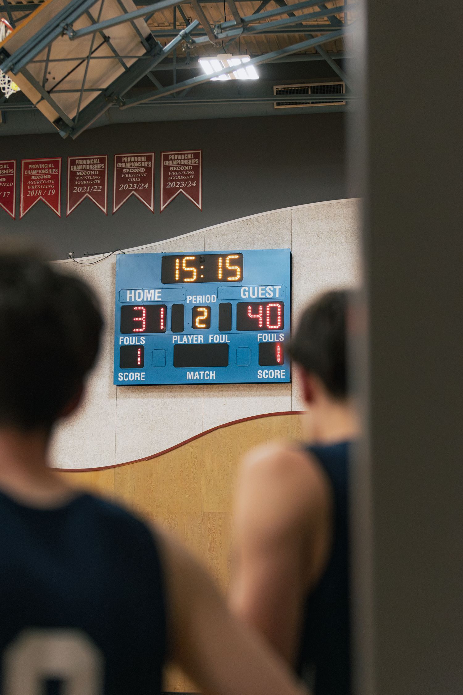 Indoor basketball scoreboard shows HOME 31, GUEST 40 with 15:15 remaining in period 2.