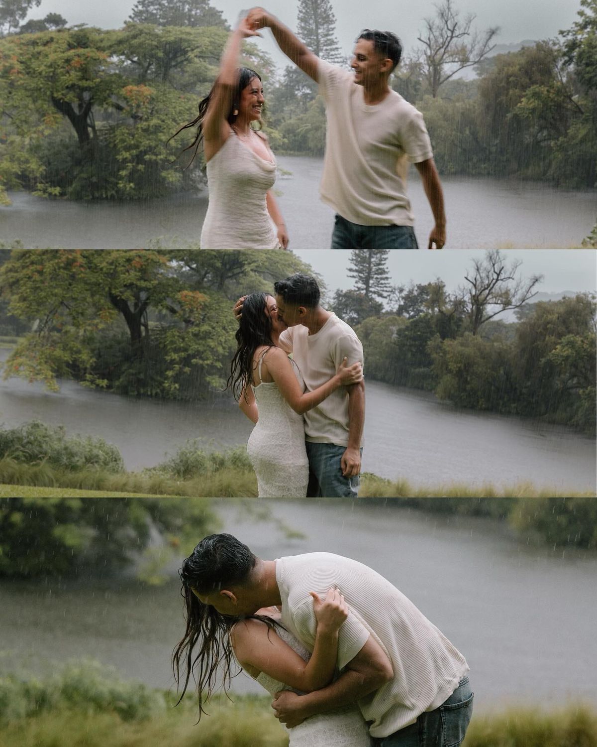 Couple dancing and kissing in the rain outdoors near a misty lake surrounded by lush green trees.